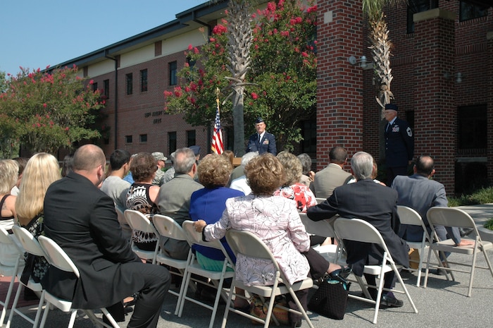 Family members listen as Col. (Ret) Jim Roberts, former 315th Operations Group Commander, speaks in a building rededication ceremony honoring Tech Sgt. Carl H. Church at the 315th Wing headquarters building. (U.S. Air Force photo/Staff Sgt. Scott Mathews)