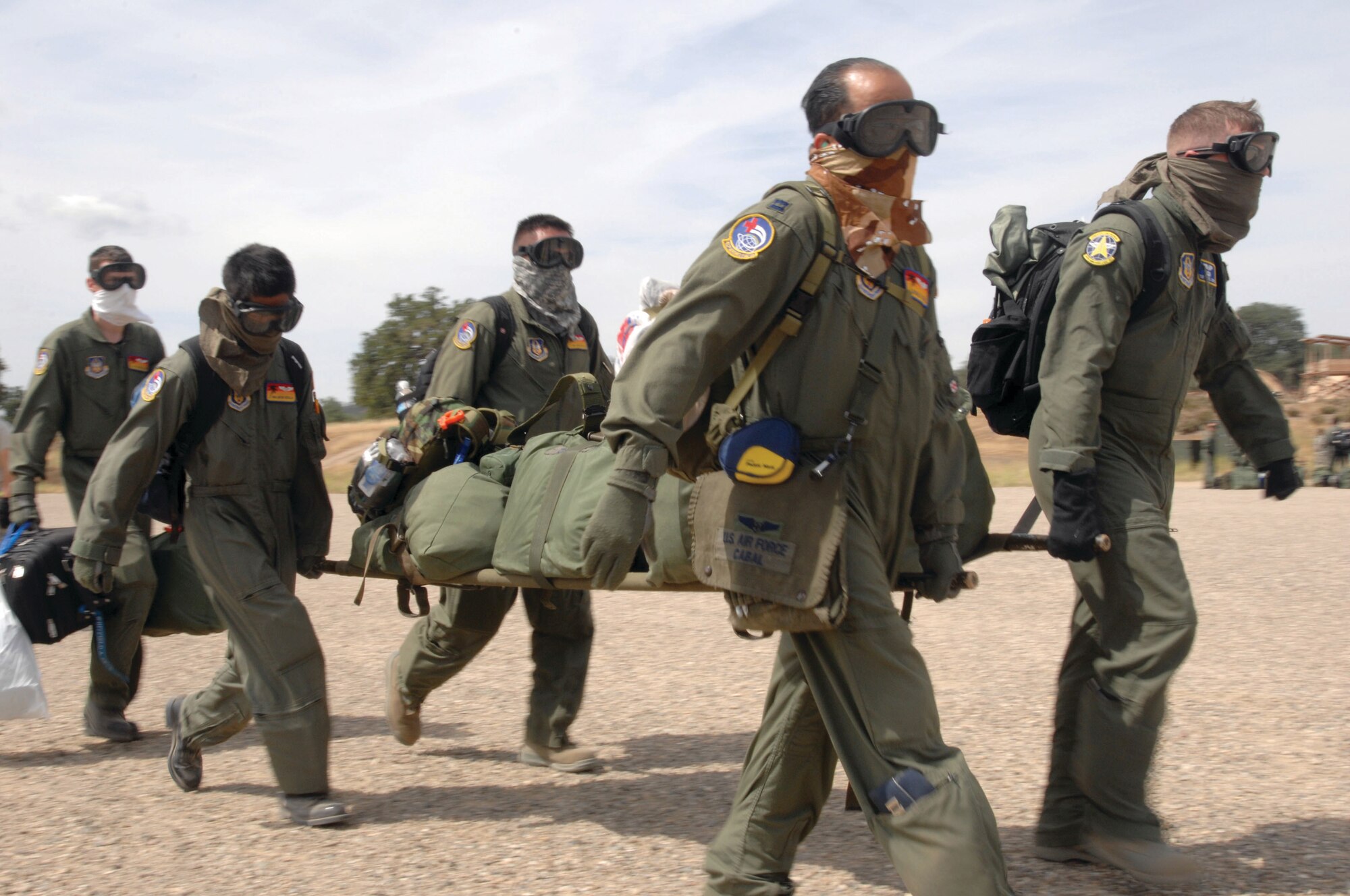 Schoonover Air Field, Calif. Air Force aeromedics from the 452nd Aeromedical Evacuation Squadron (AES) Travis Air Force Base (AFB), Callif., and 34th AES, Peterson AFB, Colo., carry a litter full of medical equipment from Schoonover Air Field, Calif. onto a C-130J Super Hercules to be transported to Castle Airport, Calif. June 12. (U.S. Air Force photo by Senior Master Sgt Michael Du)