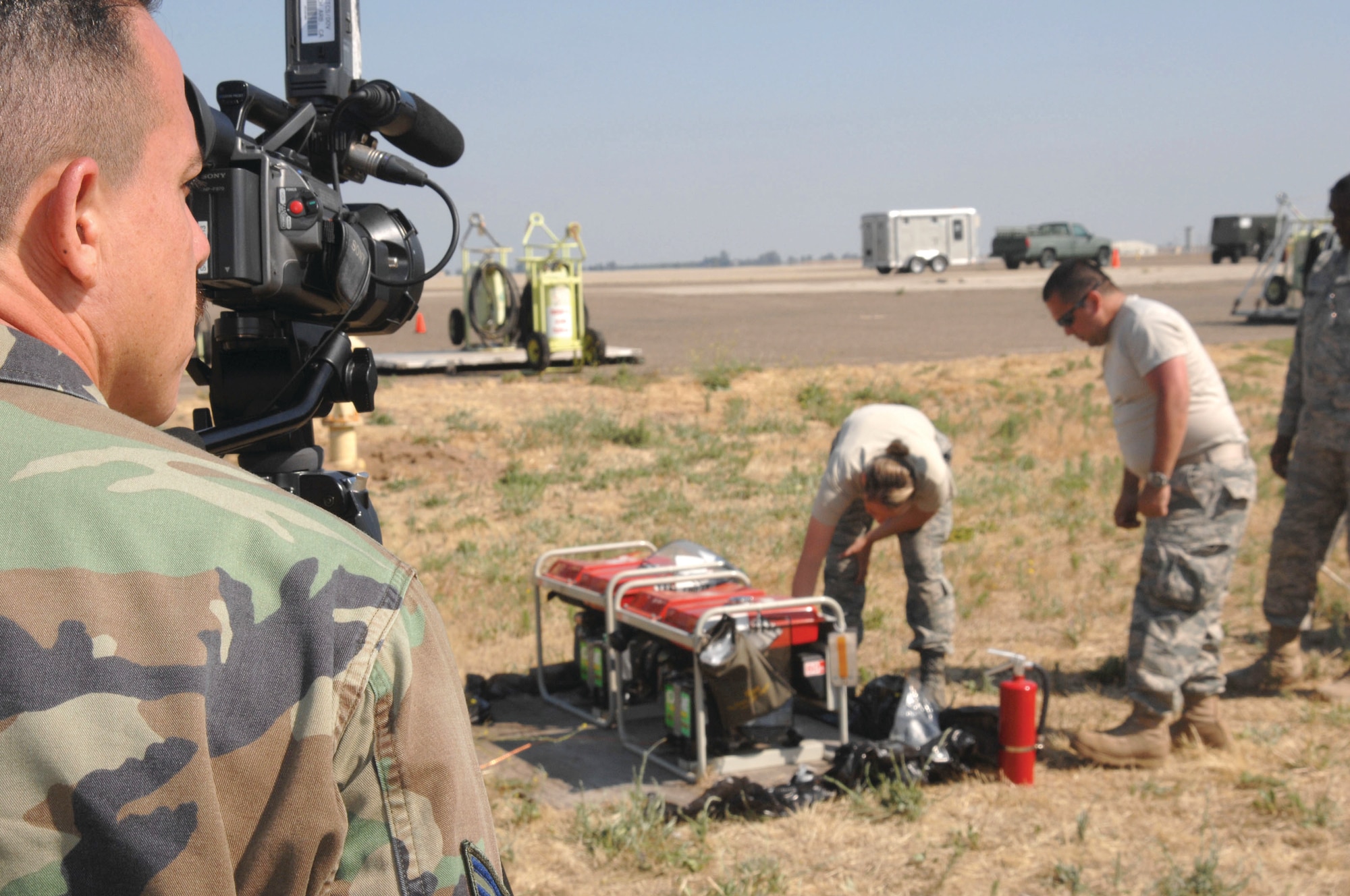 Castle Airport Atwater, Calif. Senior Airman Ruffie Molina, 4th Combat Camera Squadron, March Air Reserve Base, Calif., documents the setup of portable generators for the communications tent on June 11, at Castle Airport, Atwater, Calif. (US Air Force photo/ Senior Master Sgt. Michael Du)