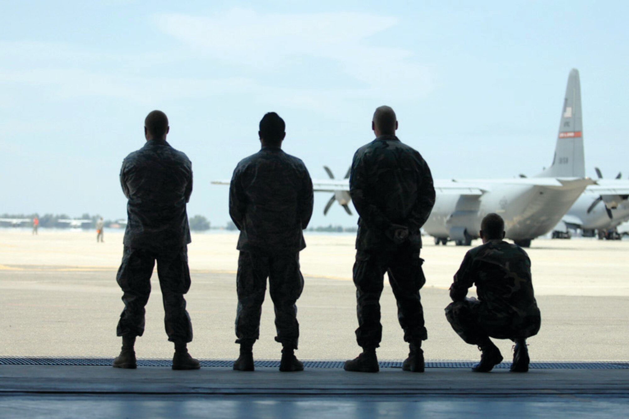 Castle Airport, Atwater, Calif. U.S. Air Force crewmembers from the 452nd Aeromedical Evacuation Squadron, March Air Reserve Base, Calif., watch as a C-130 J Super Hercules departs during Exercise Global Medic 2009, June 14. (U.S. Air Force photo by Staff Sgt. Dori Jones)