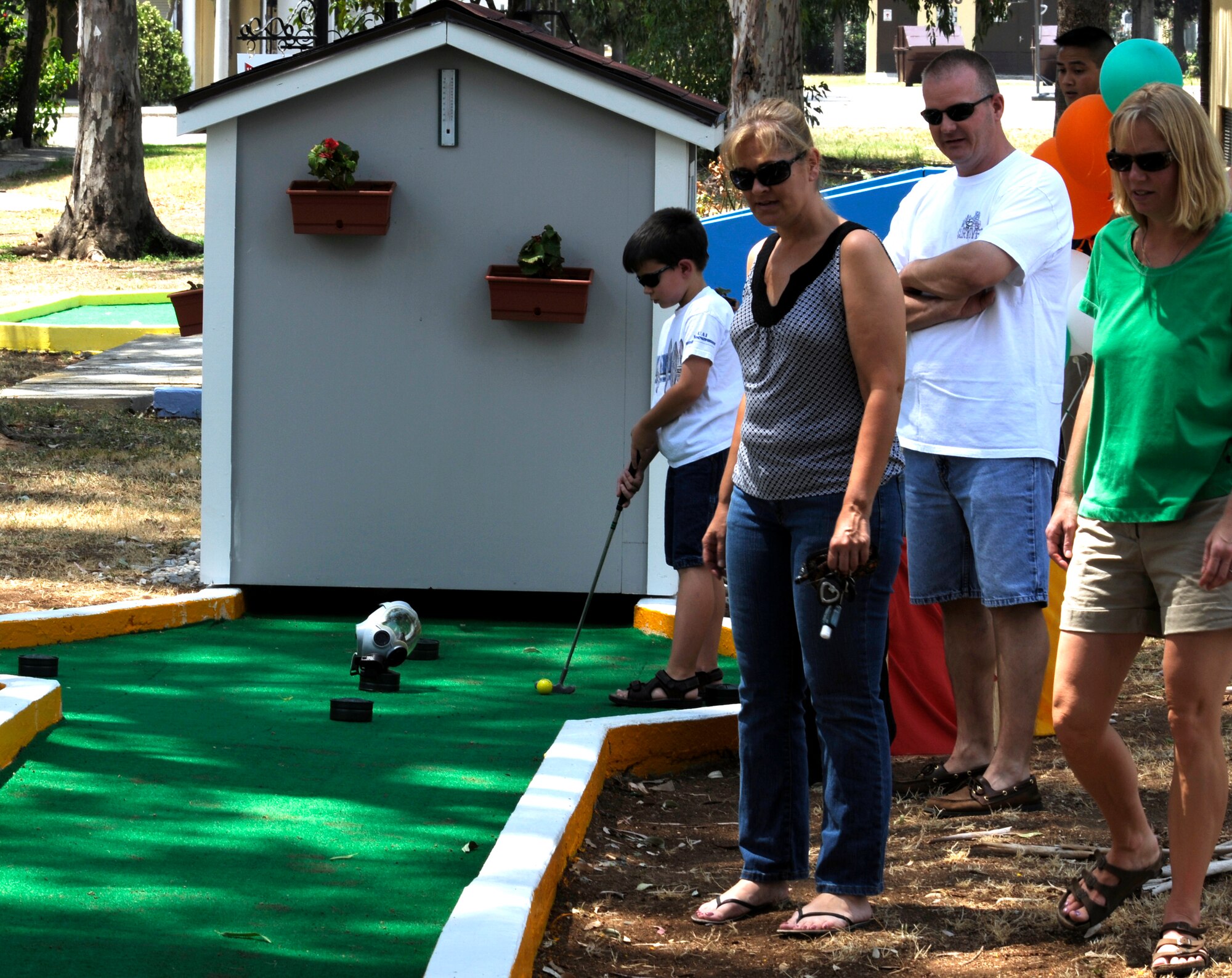 Incirlik families try out the various remodeled holes Saturday, July 25, 2009, during the official re-openning of the miniature golf course on Incirlik Air Base, Turkey.  The golf course had been closed for some time to remodel the holes.  Various organizations throughout the base sponsored the remodelling a specific hole.  (U.S. Air Force photo/Staff Sgt. Raymond Hoy) 