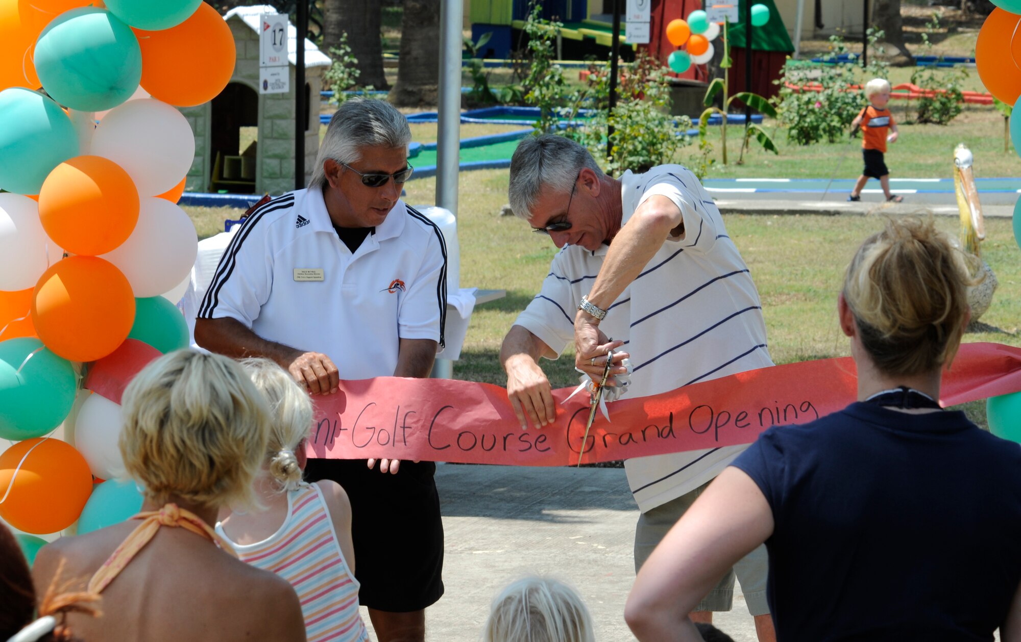 Col. Philip McDaniel cuts the ribbon Saturday, July 25, 2009, to officially re-open the miniature golf course on Incirlik Air Base, Turkey.  The golf course had been closed for some time to remodel the holes.  Various organizations throughout the base sponsored the remodelling a specific hole.  (U.S. Air Force photo/Staff Sgt. Raymond Hoy) 