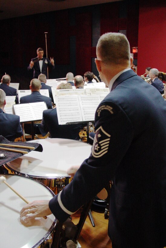 December 2, 2006: SMSgt William Drury conducts the concert band at a holiday concert in Winchester, MA.  MSgt Kevin Martin, band first sergeant, is playing the tympani (back to camera).