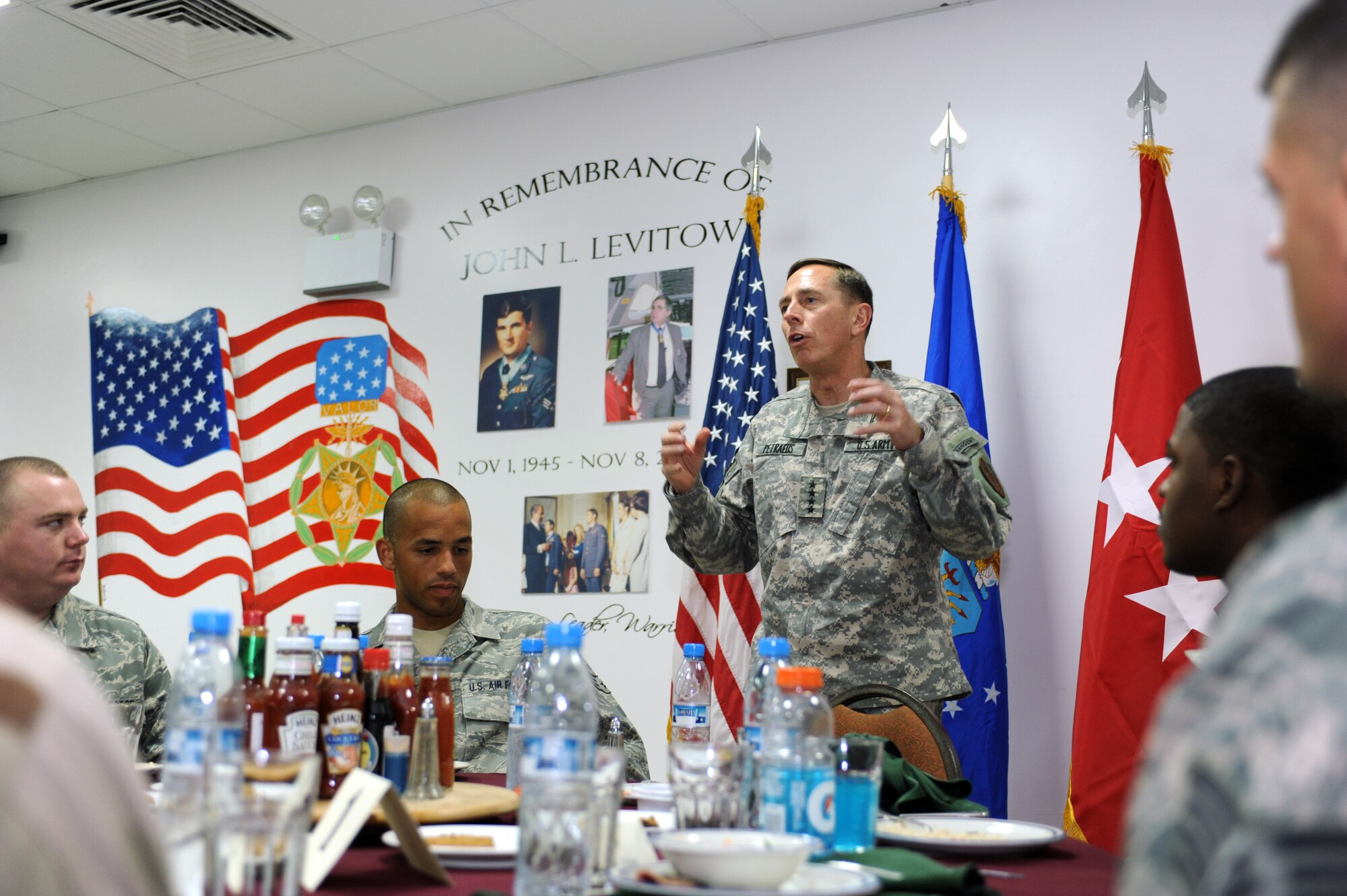 SOUTHWEST ASIA - Gen. David Petraeus, commander, United States Central Command, speaks to Soldiers and Airmen during lunch July 24. General Petraeus then proceeded to recognize military members with more than 18 months total time deployed by presenting them with a coin. (U.S. Air Force photo Tech. Sgt. Charles Larkin Sr)