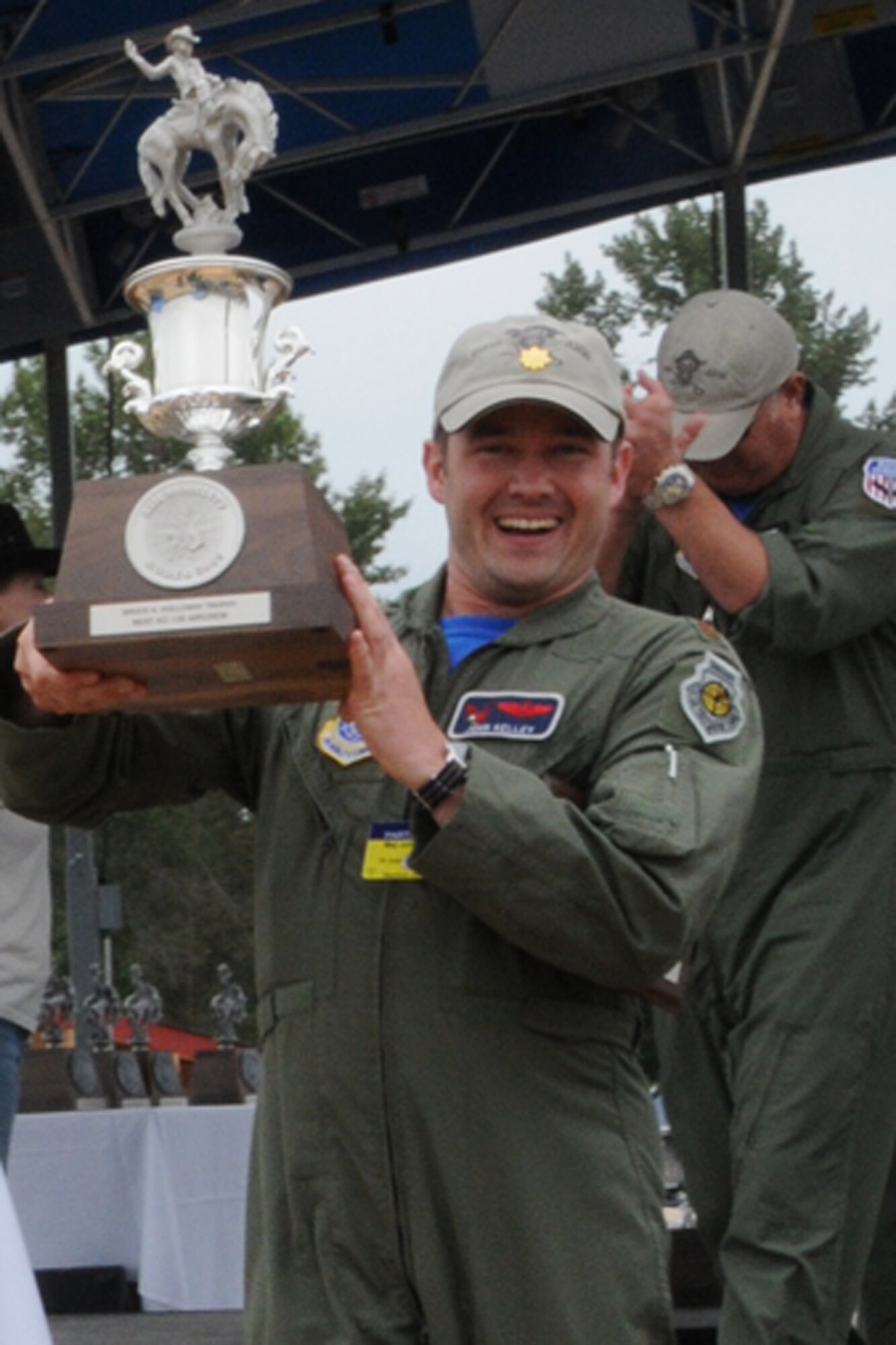 SEYMOUR JOHNSON AIR FORCE BASE, N.C. -- Maj. John Kelley hoists the Best KC-135 Aircrew trophy high as he walks off stage at RODEO 2009. The combined active duty and Reserve 916th tanker team took top honors at the international airlift competition.