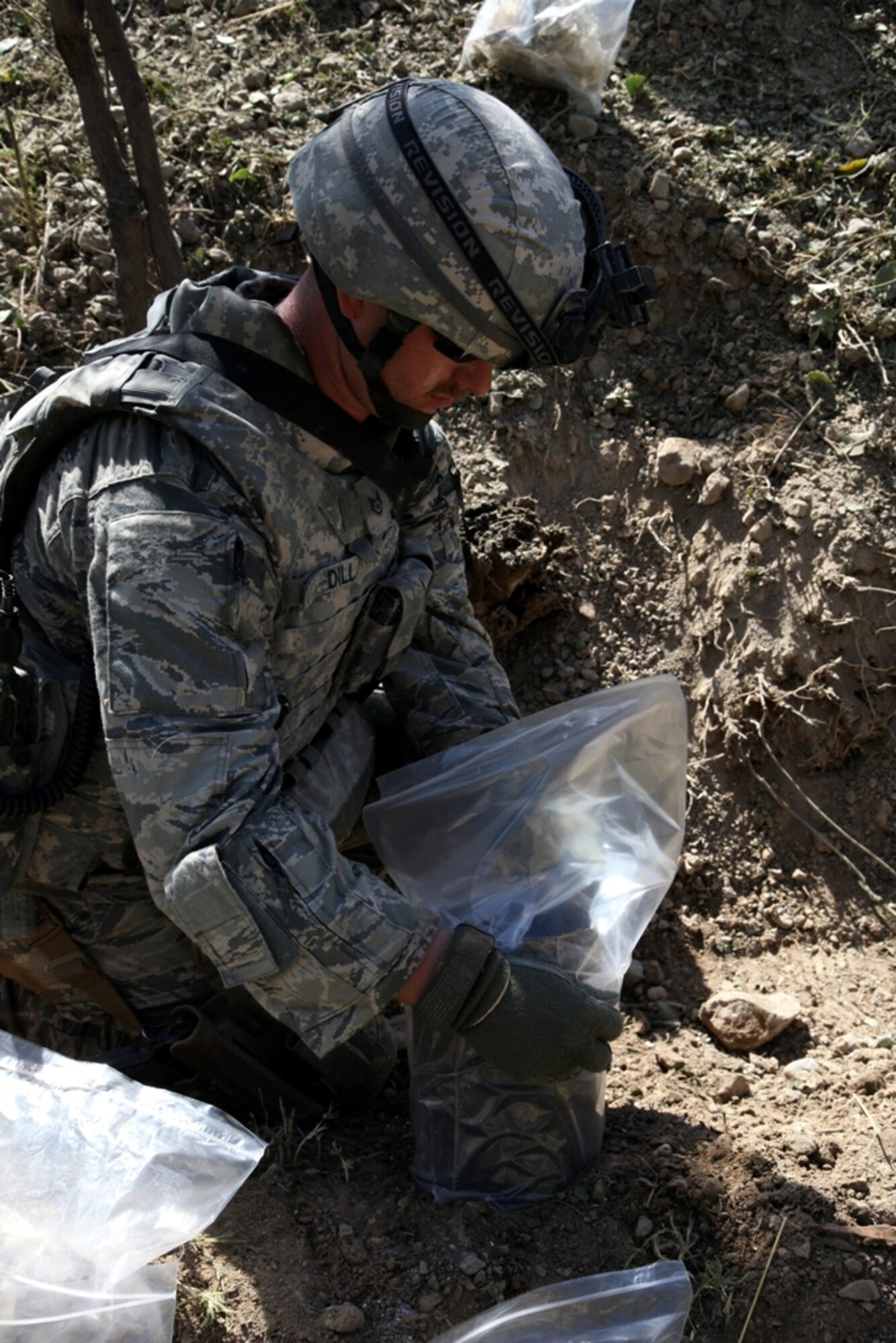 LOGAR PROVINCE, Afghanistan - Staff Sgt. Carl Dill bags up remains of a controlled Improvised Explosive Device in Logar province, Afghanistan, July 15. Dill is currently serving with the 741st Explosive Ordnance Device Battalion, Task Force Spartan, 3rd Brigade Combat Team, 10th Mountain Division. (U.S. Army photo/Pfc. Richard W. Jones Jr.)