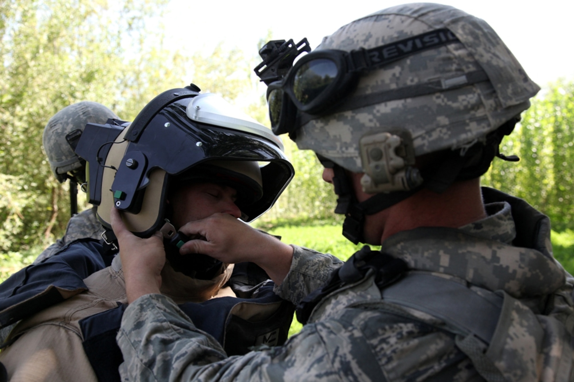 LOGAR PROVINCE, Afghanistan - Staff Sgt. Thomas Becker assists Tech Sgt. Brandon Livingston with his bomb suit in Logar province, Afghanistan, July 15. Becker and Livingston are currently assigned to the 741st Explosive Ordnance Device Battalion, Task Force Spartan, 3rd Brigade Combat Team, 10th Mountain Division. (U.S. Army photo/Pfc. Richard W. Jones Jr.)

