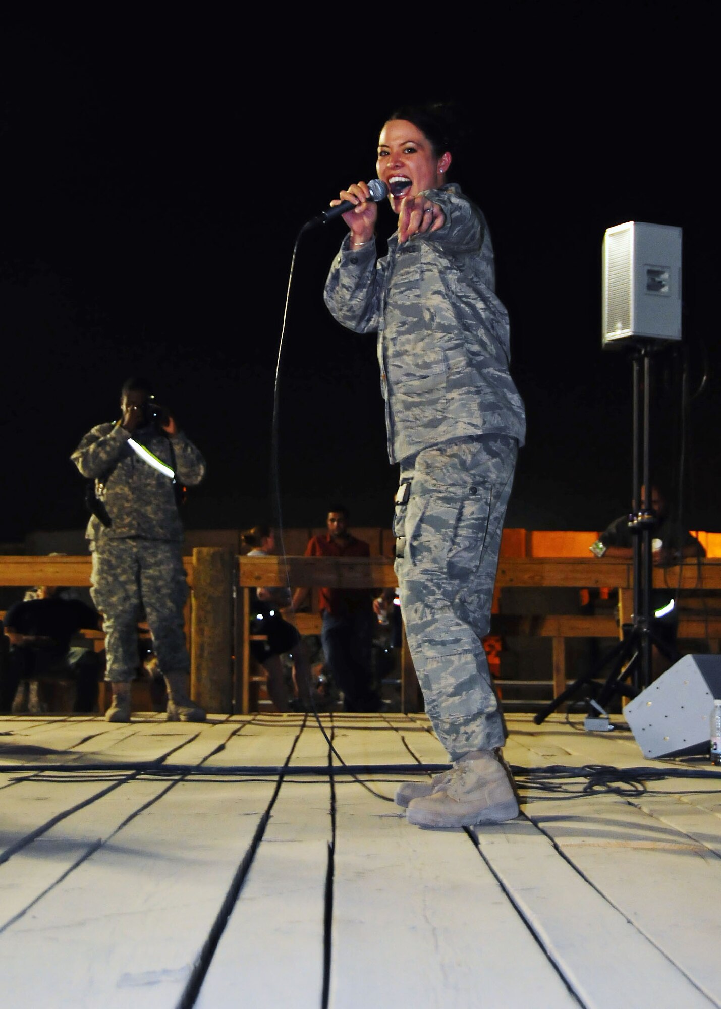 CAMP BUCCA, Iraq-- Staff Sgt. Angie Long, Air Force Central Command Sonora band, sings during a performance for members of Camp Bucca, Iraq on July 22.  Sonora offers a diverse performance repertoire featuring acoustic, electric and bass guitars, keyboards, drums, saxophone and trumpet.  Vocalists round-out the mix and an expert engineer brings it all together.  Sergeant Long is deployed from the 131st Fighter Wing, Air National Guard, Mo., and hails from Nashville, Tenn.  (U.S. Air Force photo/Tech Sgt. Tony Tolley)