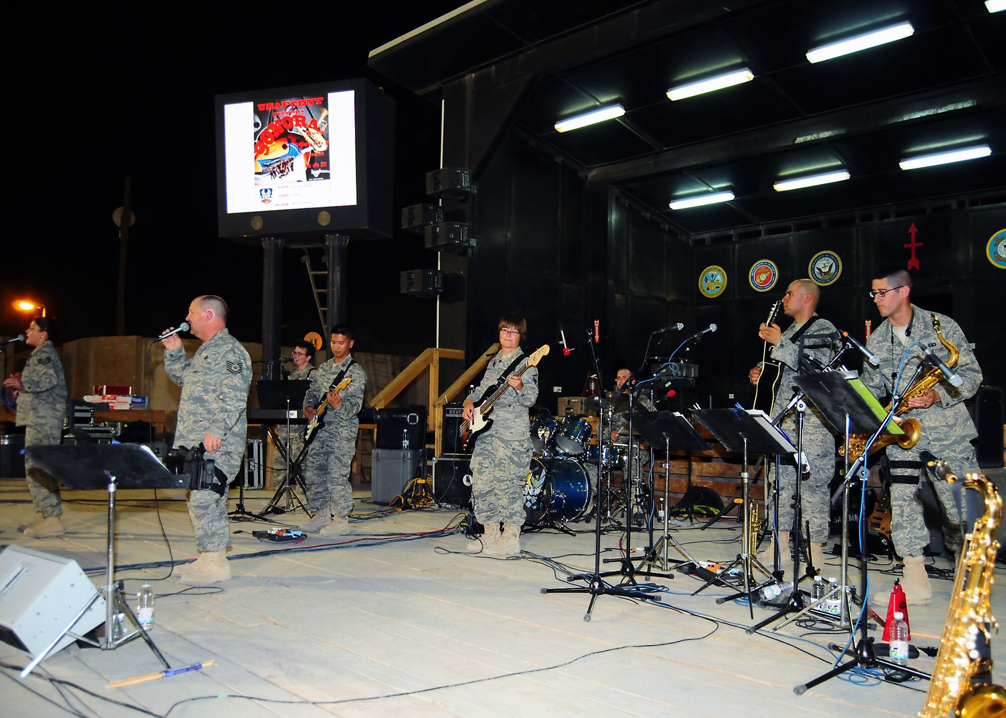 CAMP BUCCA, Iraq-- Air Force Central Command band Sonora perform for members of Camp Bucca, Iraq, during a performance on July 22.  Sonora offers a diverse performance repertoire featuring acoustic, electric and bass guitars, keyboards, drums, saxophone and trumpet.  Vocalists round-out the mix and an expert engineer brings it all together.  (U.S. Air Force photo/Tech Sgt. Tony Tolley)