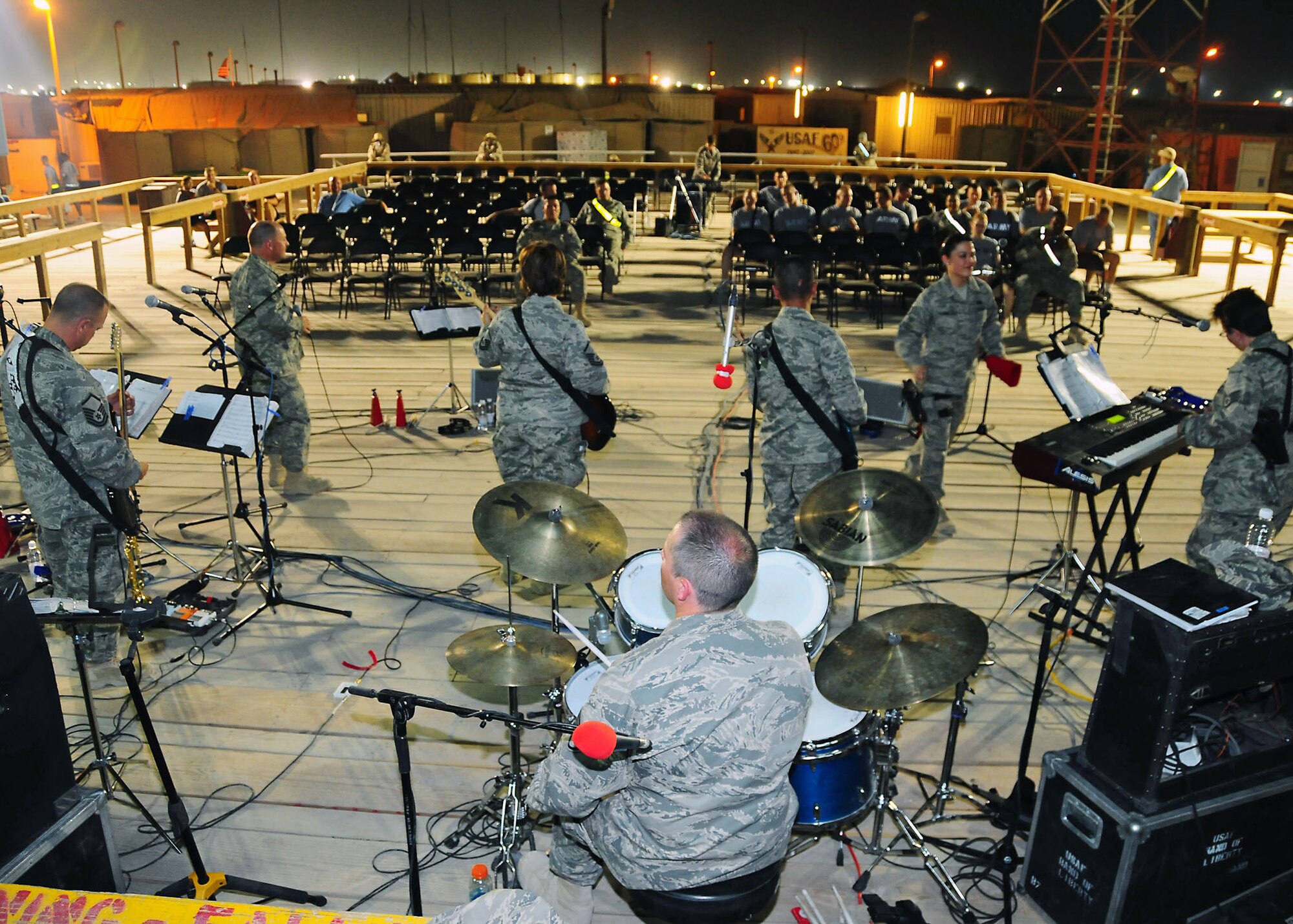 CAMP BUCCA, Iraq-- Air Force Central Command band Sonora perform for members of Camp Bucca, Iraq, during a performance on July 22.  Sonora offers a diverse performance repertoire featuring acoustic, electric and bass guitars, keyboards, drums, saxophone and trumpet.  Vocalists round-out the mix and an expert engineer brings it all together.  (U.S. Air Force photo/Tech Sgt. Tony Tolley)