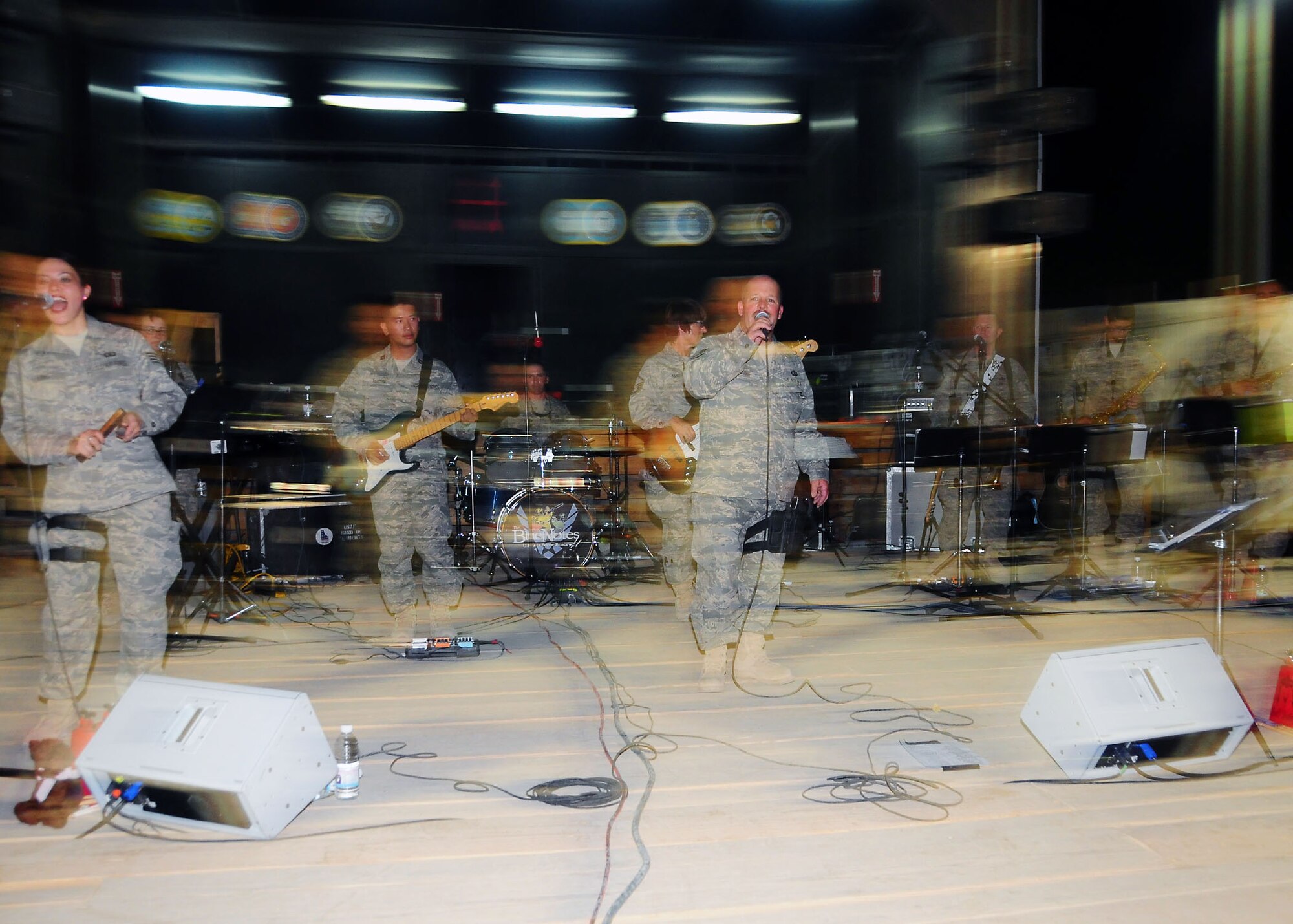 CAMP BUCCA, Iraq-- Air Force Central Command band Sonora perform for members of Camp Bucca, Iraq, during a performance on July 22.  Sonora offers a diverse performance repertoire featuring acoustic, electric and bass guitars, keyboards, drums, saxophone and trumpet.  Vocalists round-out the mix and an expert engineer brings it all together.  (U.S. Air Force photo/Tech Sgt. Tony Tolley)
