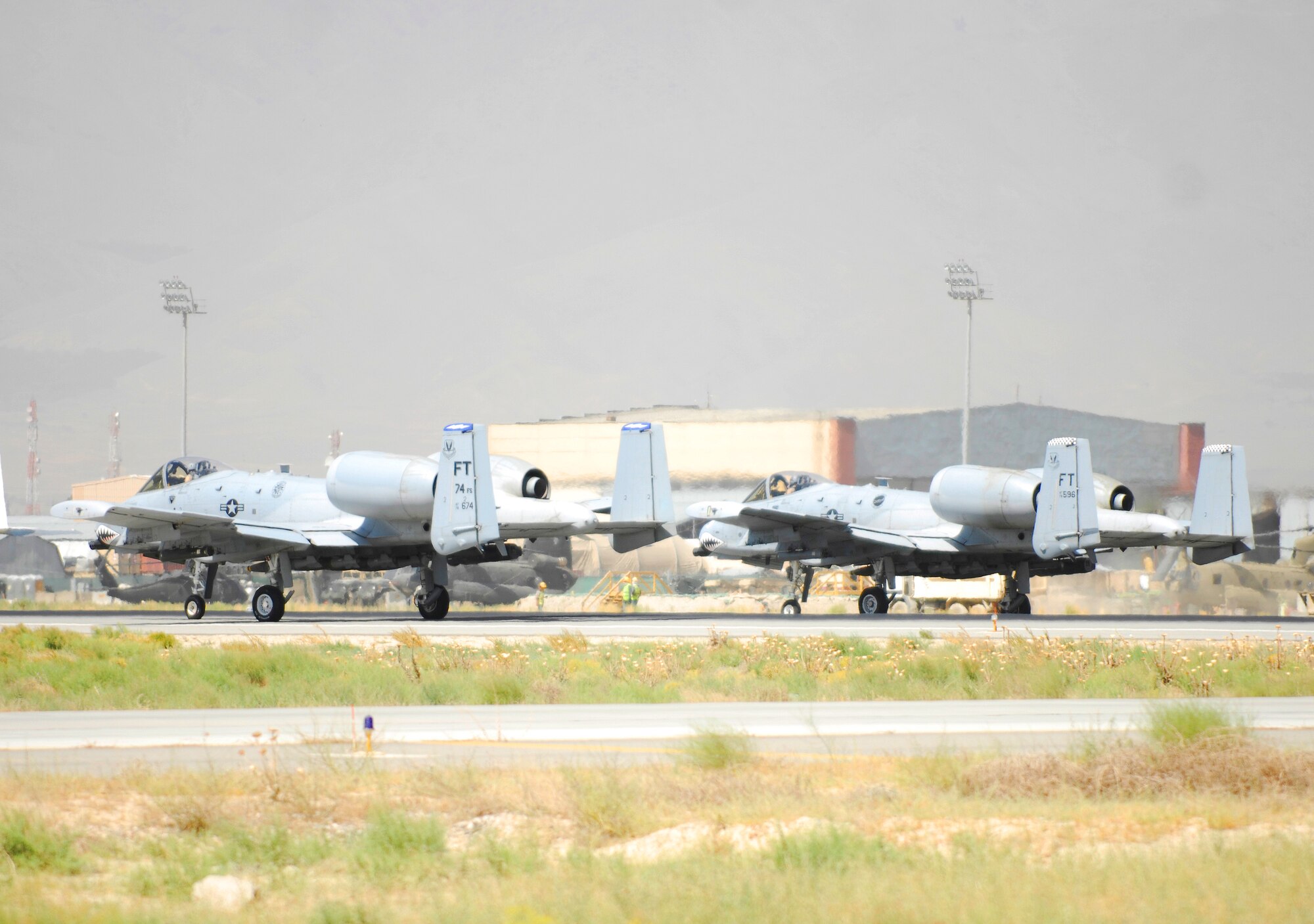BAGRAM AIRFIELD, Afghanistan - Two Warthogs from the 74th Expeditionary Fighter Squadron sit on the tarmac awaiting clearance to launch on a mission in support of Operation Enduring Freedom. The 74th EFS, deployed from Moody Air Force Base, Ga., recently surpassed 12,200 combat flight hours - a record. (U.S. Air Force photo/Tech. Sgt. John Jung)