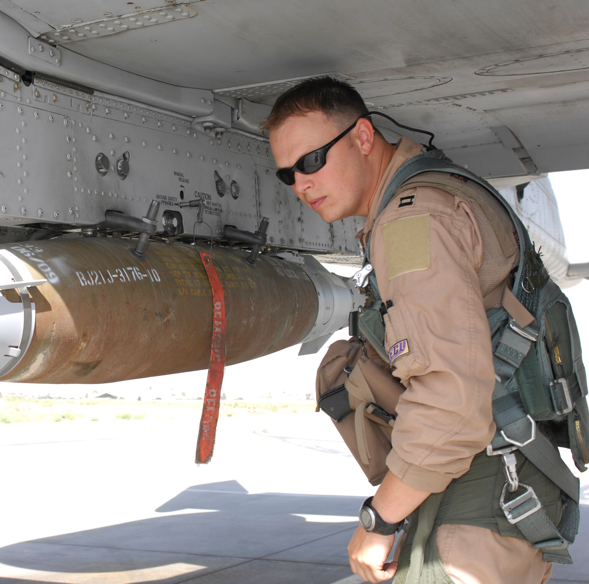 BAGRAM AIRFIELD, Afghanistan – Captain Kyle Lanto, an  A-10 pilot with the 455th Air Expeditionary Wing’s 74th Expeditionary Fighter Squadron, checks munitions on his ‘Warthog,’ during his preflight inspection here. Capt. Lanto is deployed from Moody Air Force Base, Ga., and is a native of Rantoul, Ill. Capt. Lanto is a graduate of Eastern Carolina University is currently deployed in support of Operation Enduring Freedom in Afghanistan.  Capt. Lanto’s A-10 squadron has a lineage prior to WWII and were known as the Flying Tigers and recently they’ve completed over 12,000 combat hours – a feat for any fighting unit. (U.S. Air Force photo/Tech. Sgt. John Jung)