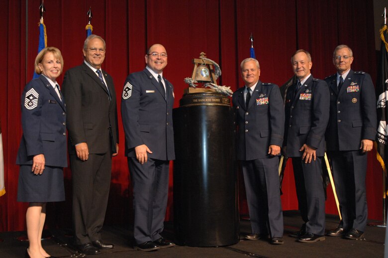 From left to right, Chief Master Sgt. Patricia Thornton, Fourth Air Force Command Chief; Mr. Roger Rupp, Greater Riverside Chambers of Commerce Military Affairs Committee Chairman; Brig. Gen. James Melin, 452nd Air Mobility Wing Commander; Chief Master Sgt. Agustin Huerta, 452nd AMW Command Chief;  Brig. Gen. Eric W. Crabtree, Headquarters Fourth Air Force  Commander; and Maj. Gen. John M. Howlett, Deputy Director, U.S. Strategic Command, pose with the Raincross Trophy after it was awarded to the 452nd AMW during the 11th Annual Raincross Trophy Dinner held July 23, 2009, at the Riverside Convention Center, Riverside, Calif.. The dinner is hosted by the Greater Riverside Chambers of Commerce Military Affairs Committee to honor and recognize the 11 wings and two groups in 4th Air Force.  (U.S. Air Force photo/ Senior Master Sergeant Kim Allain)  (released)
