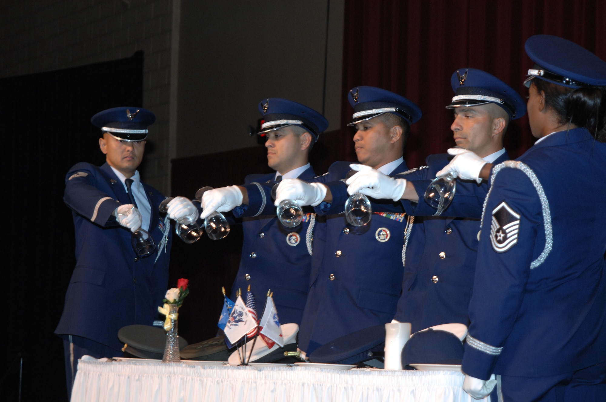 Six members of the Fourth Air Force Honor Guard invert glasses to remind us that our prisoners of war and those missing in action are with us in spirit at the 11th Annual Raincross Trophy Dinner held July 23, 2009, at the Riverside Convention Center, Riverside, Calilf. The dinner is hosted by the Greater Riverside Chambers of Commerce Military Affairs Committee to honor and recognize the 11 wings and two groups in Fourth Air Force.  (U. S. Air Force phot/Senior Master Sgt. Kim Allain)  (released)
