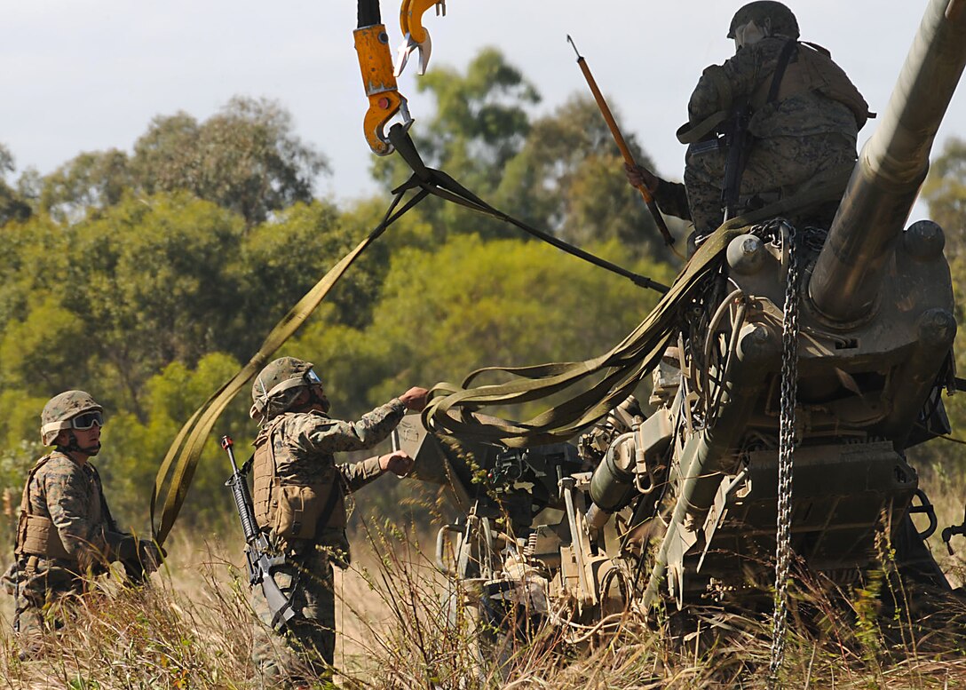 U.S. Marines rig an M-777 105 mm lightweight howitzer for lifting by an MH-53E Sea Stallion helicopter during Talisman Saber, a training exercise in Shoalwater Bay, Australia, July 19, 2009. The Marines are embarked aboard the amphibious assault ship USS Essex, and the helicopter is assigned to the Air Combat Element of the 31st Marine Expeditionary Unit.