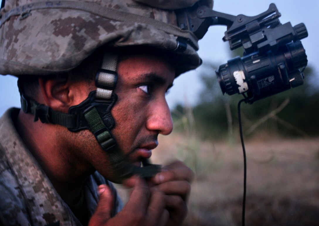 Lance Cpl. Jacob Ramirez, 24, from Fresno, Calif., prepares his night-vision equipment before participating in a live-fire night raid with Company F, Battalion Landing Team 2/4, here July 26.