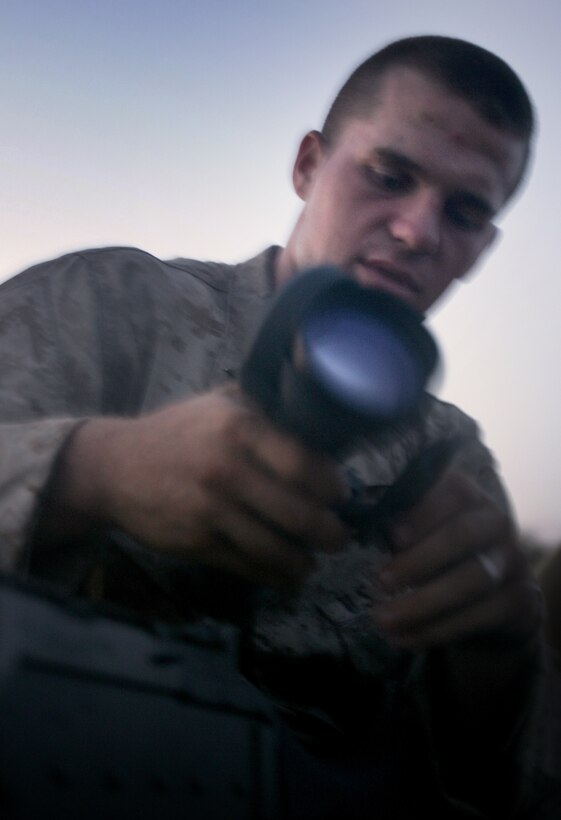 Lance Cpl. Jacob M. Turner, 22, from Tulsa, Okla., mounts a night-vision scope onto his machine gun before a live-fire night raid with Company G here July 26. The raid was part of Battalion Landing Team 2/4’s second of three training periods at sea before the team deploys with the 11th Marine Expeditionary Unit later this year.