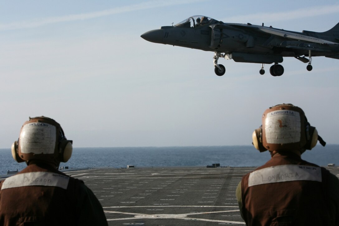 An AV-8B Harrier with Marine Attack Squadron 513 Detachment A, currently attached to Marine Medium Helicopter Squadron 166 (Rein), approaches the flight deck of USS Cleveland during deck landing qualifications July 26. Six Harrier pilots with HMM-166, the 11th Marine Expeditionary Unit’s aviation combat element, qualified in landing on the small amphibious ship so they can execute planned and emergency operations if needed.