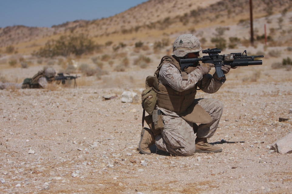Lance Cpl. Gilbert Andrade, a rifleman with Company K, 3rd Battalion, 7th Marine Regiment, and a native of Rancho Cucamonga, Calif., lays down coveringfire - for other Marines in his firing team July 28, at Combat Center Range 1A.
