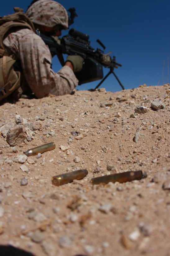 Lance Cpl. Christopher Massey, a rifleman with Company I, 3rd Battalion, 7th Marine Regiment, sends rounds down range July 28, at Combat Center Range 105A when his company conducted fire team rushes as part of their pre-deployment training.