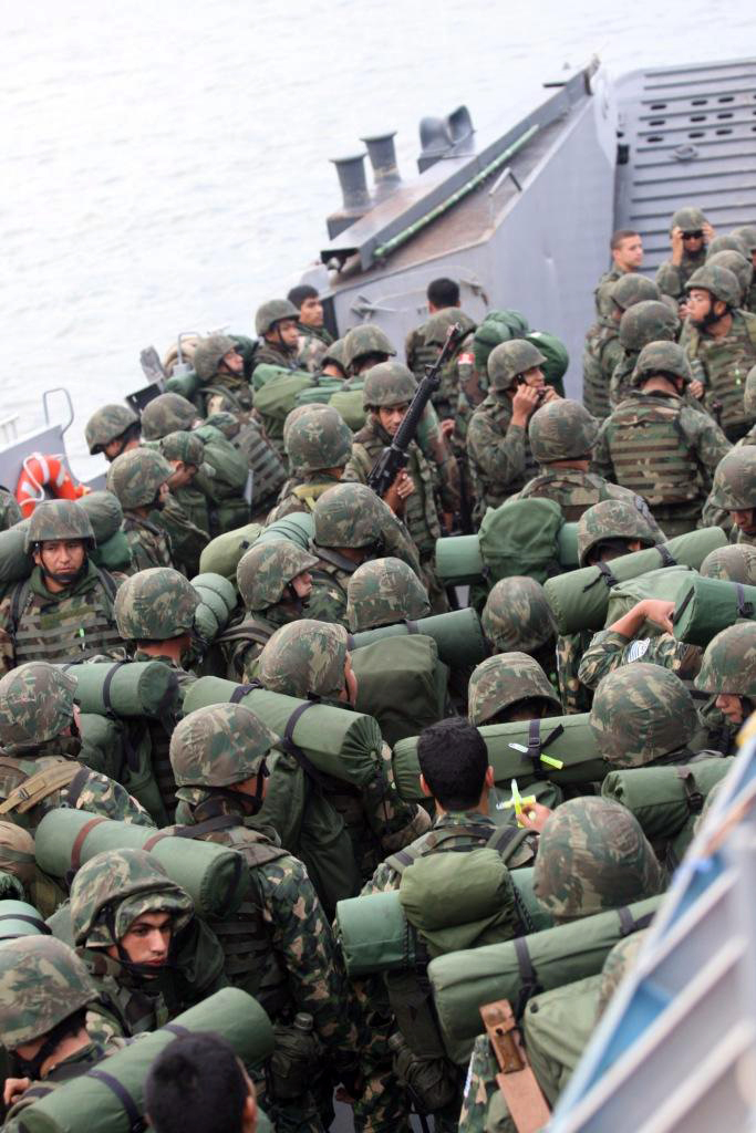 Marines from seven countries prepare to unload from a Landing Craft Unit (LCU) on the island of Marambaia, off the coast of Rio de Janeiro, Brazil, for the Final Exercise portion of Southern Exchange 2009 (SE09). The FINEX was a two-day peace-keeping operation in which participants showcased the previous two weeks worth of training during the multi-national exchange. (Marine Corps photo by Lance Cpl. Jonathan G. Wright/Released)
