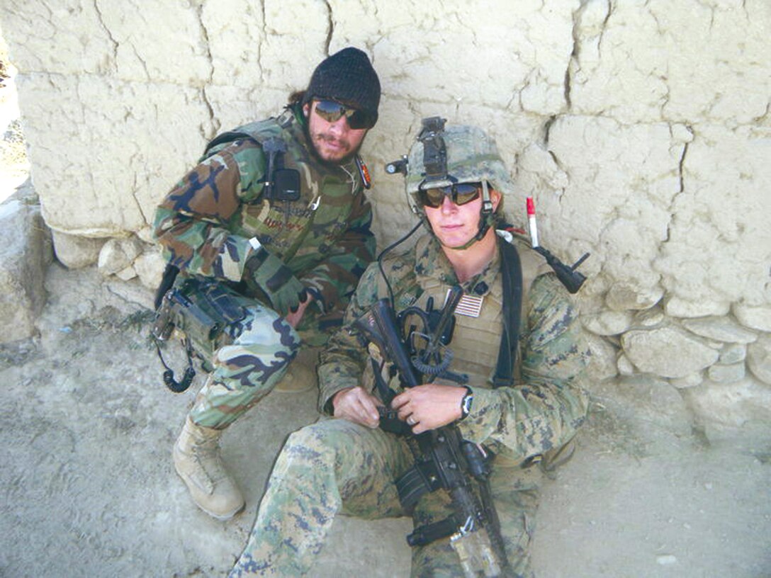 Petty Officer 3rd Class Zackary S. Hammonds, right, a corpsman with Marine Wing Support Group 17, 1st Marine Aircraft Wing, III Marine Expeditionary Force, poses with his Afghan interpreter while deployed to Afghanistan with Regional Corps Advisory Command 3-7.