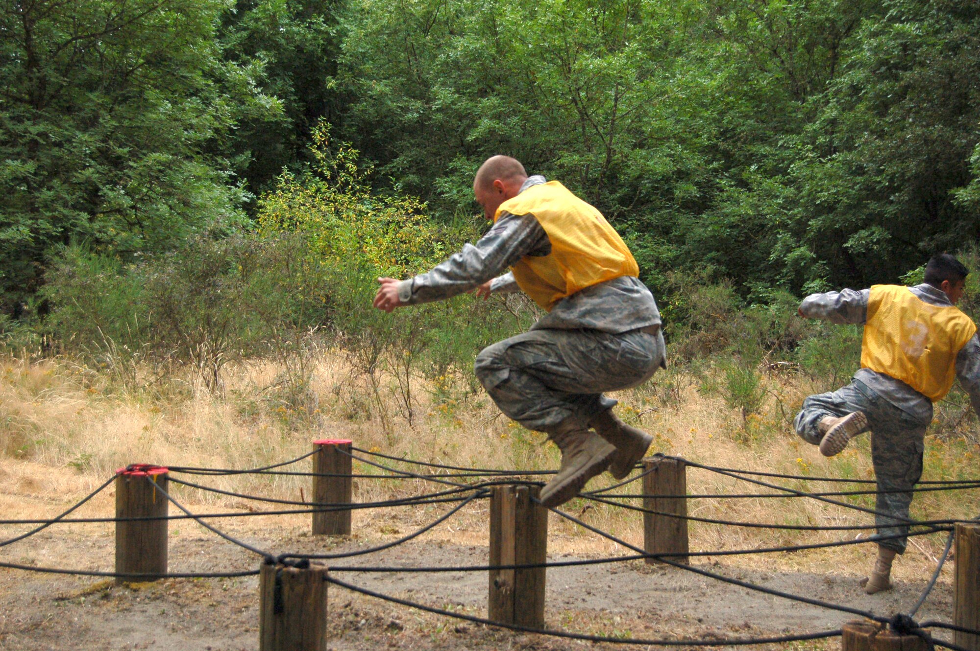 Senior Airman Shawn LaQue, 319th Security Forces Squadron, leaps through the obstacle course during the combat endurance portion of the Air Mobility RODEO competition July 23 at McChord Air Force Base, Wash. (U.S. Air Force photo/Tech. Sgt. Amanda Callahan)