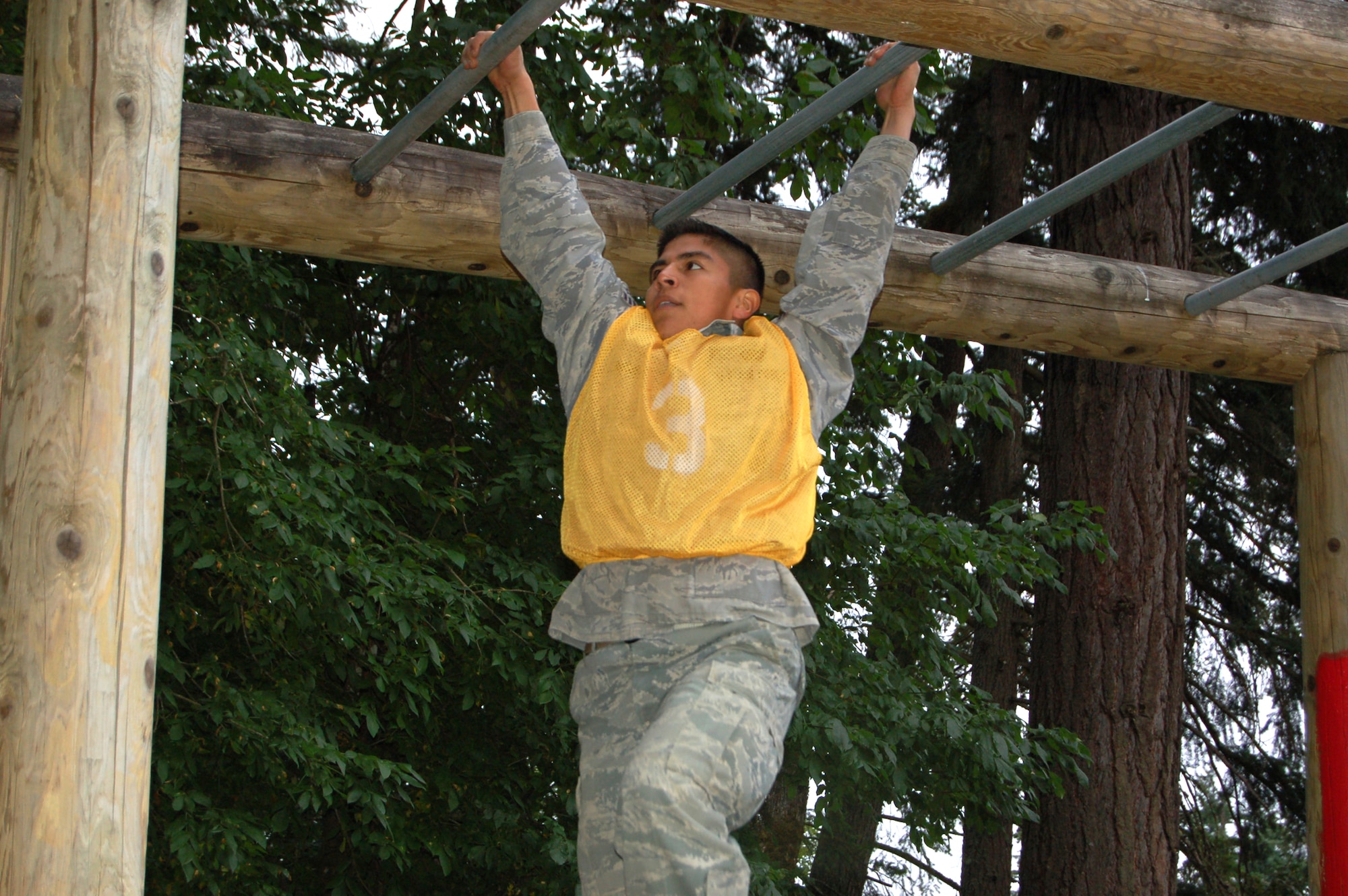 Senior Airman Alfredo Mejia, 319th Security Forces Squadron, scrambles across monkey bars during the combat endurance competition portion of the Air Mobility RODEO July 23 held at McChord Air Force Base, Wash. RODEO is the U.S. Air Force's and Air Mobility Command's premier air mobility competition.  (U.S. Air Force photo/Tech. Sgt. Amanda Callahan)