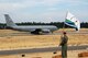 A Grand Forks Air Force Base KC-135 taxis in preparation to take flight as team lead, Lt. Col. Seth Beaubien, waves the Grand Forks flag proudly at McChord AFB, Wash., July 21 during the Air Mobility RODEO competition. RODEO is an international combat skills and flying operations competition designed to develop and improve techniques and procedures that enhance air mobility operations and to promote esprit de corps, optimizing mobility partnerships.  (U.S. Air Force photo/Tech. Sgt. Amanda Callahan)