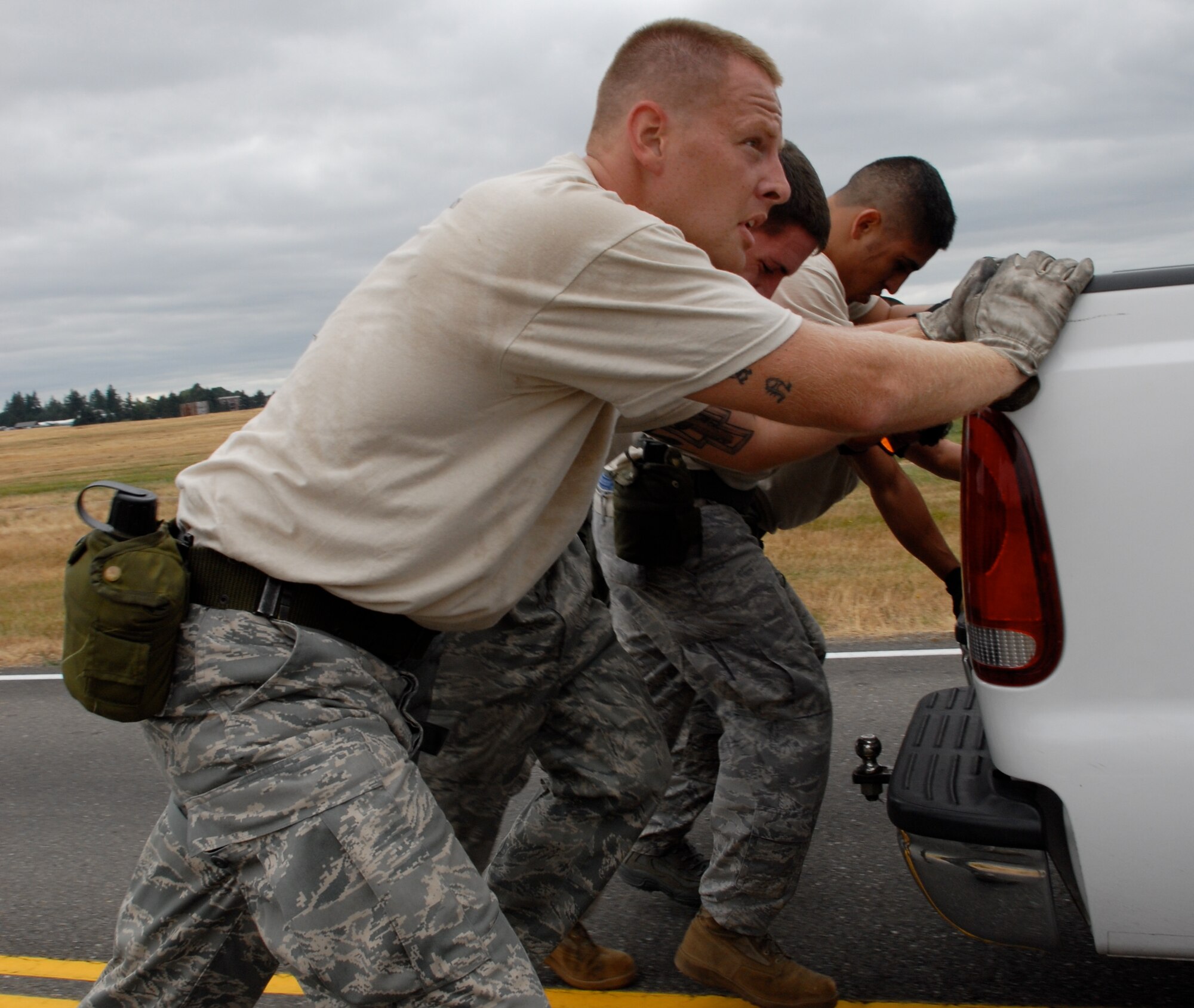 MCCHORD AIR FORCE BASE, Wash. – The 515th Air Mobility Operations Wing Air Mobility Rodeo 2009 Pacific aerial porters Staff Sgt. Travis Wilt, 733rd Air Mobility Squadron, Kadena Air Base, Japan; Staff Sgt. Clifton Robertson, 735th Air Mobility Squadron, Hickam Air Force Base, Hawaii; Senior Airman Tito Valdez, 731st Air Mobility Squadron, Osan Air Base, Korea, Staff Sgt. Dustin Barboza, 734th Air Mobility Squadron, Andersen Air Base, Guam; and Senior Airman Andrew Cramer, 732th Air Mobility Squadron, Elmendorf Air Force Base, Alaska, push a pickup truck during the Aerial Porters Combat Challenge here July 23. During the challenge, aerial porters had to sprint along a four-mile course, stopping to overcome physical and mental obstacles. They finished the entire course in 57 minutes and 26 seconds. The 515th AMOW team is an eight-person group of Airmen who were hand-picked from more than 500 other aerial porters in the Pacific to compete in the Rodeo 2009 competition July 19 to 25 here. Prior to the Rodeo, they trained together at Hickam Air Force Base, Hawaii, for seven weeks. (U.S. Air Force photo/Staff Sgt. Carolyn Viss)