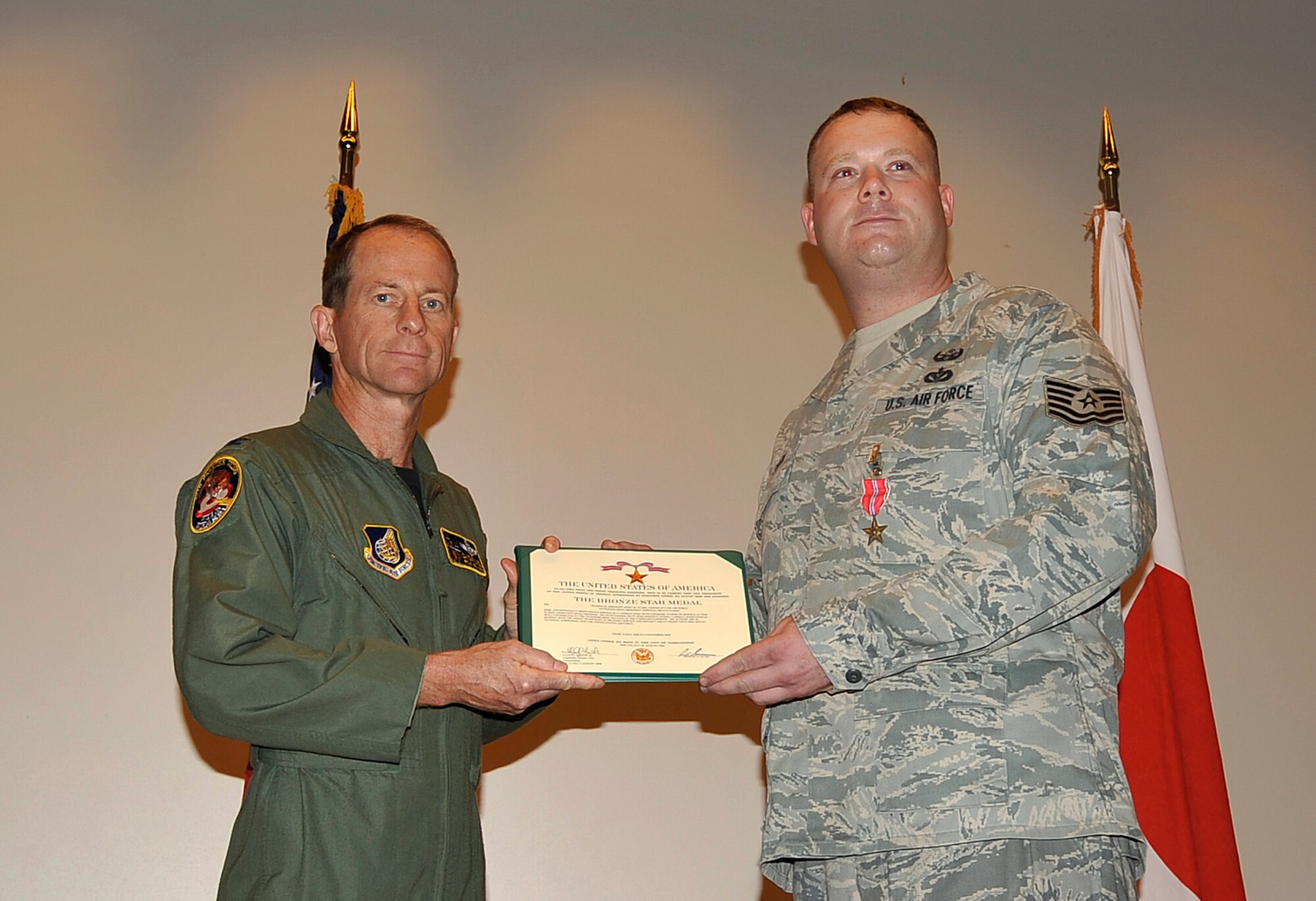 MISAWA AIR BASE, Japan -- Tech. Sgt. Rory Stark, 35th Civil Engineer Squadron Explosive Ordnance Disposal technician, receives the Bronze Star July 25 from Col. David Stilwell, 35th Fighter Wing commander, for his actions in theater. Sergeant Stark was deployed to Forward Operating Base Loyalty, Iraq from May 4, 2008 to November 4, 2008 during Operation Iraqi Freedom. (U.S. Air Force photo/Senior Airman Chad C. Strohmeyer)