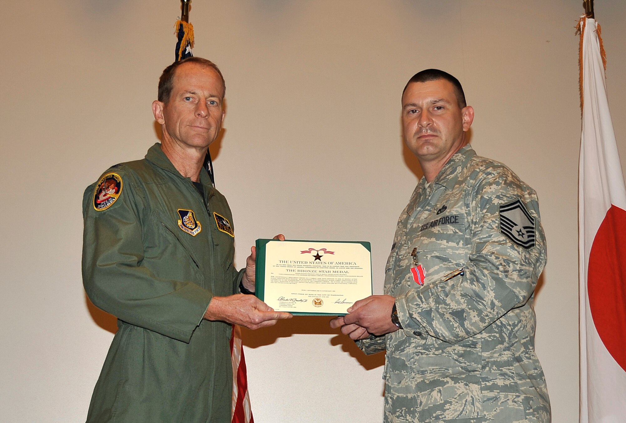 MISAWA AIR BASE, Japan -- Senior Master Sgt. John Mazza, 35th Civil Engineer Squadron superintendent, receives the Bronze Star July 25 from Col. David Stilwell, 35th Fighter Wing commander, for his actions in theater. Sergeant Mazza was deployed to Joint Base Balad, Iraq from September 3, 2008 to February 28, 2009 during Operation Iraqi Freedom. (U.S. Air Force photo/Senior Airman Chad C. Strohmeyer)