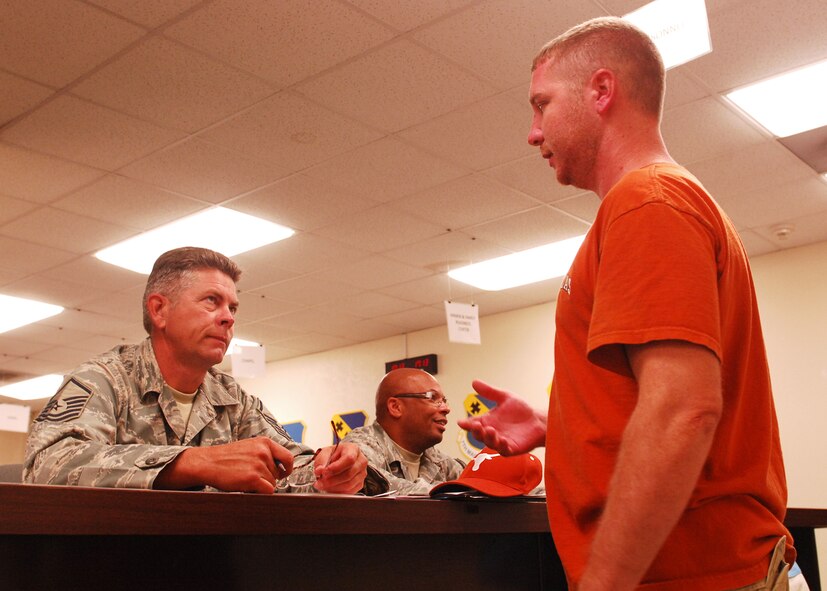 Master Sgt. Dean Fitzpatrick, in-service recruiter from Goodfellow AFB, talks to Staff Sgt. Jesse Shilling after the individual ready reserve muster briefings here June 25. The purpose of the muster is to gather IRR members, and to maintain their contact information and availability for activation to support a partial, total or full mobilization activation scenario. The IRR is made up of former regular Air Force Airmen and non-drilling reservists. (U.S. Air Force photo by Airman 1st Class Chelsea L. White)