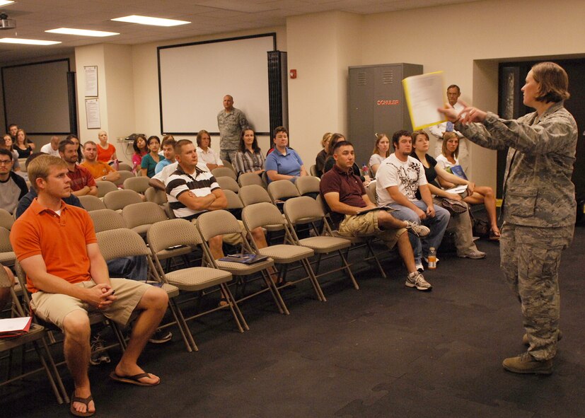 Capt. Heather Wempe, 7th Force Support Squadron, addresses individual ready reserve muster participants here June 25. The purpose of the muster is to gather IRR members, and to maintain their contact information and availability for activation to support a partial, total or full mobilization activation scenario. The IRR is made up of former regular Air Force Airmen and non-drilling reservists. (U.S. Air Force photo by Airman 1st Class Chelsea L. White)
