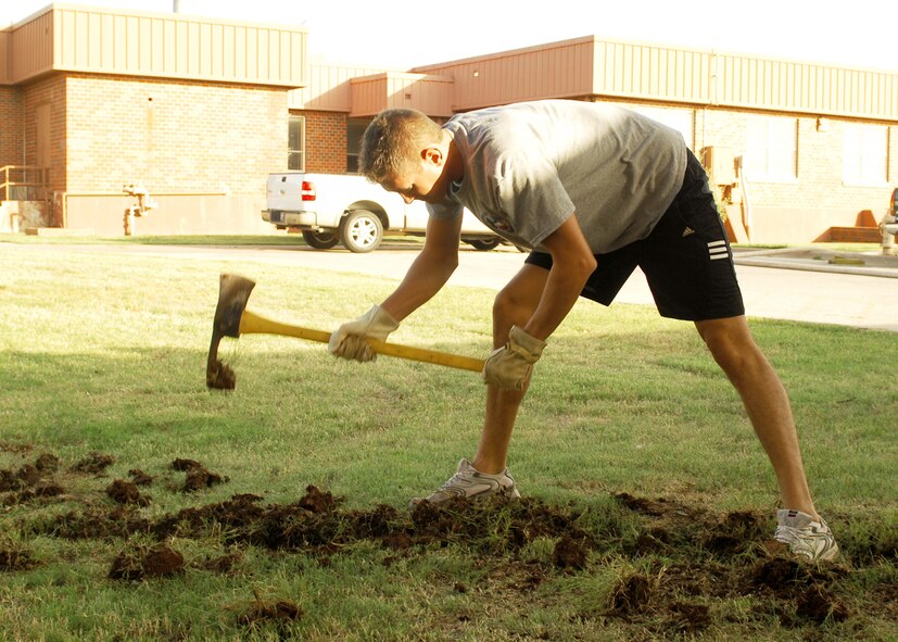 Senior Airman Stefan Meyers, 7th Communications Squadron, digs a trench for water drainage outside the Soul Fire Café here June 25. Airman Leadership School students volunteer to clean up the Soul Fire Café as part of a community service program. The Soul Fire Café is open to all Airman Thursdays 4:30 to 9p.m. and Friday and Saturday 1 p.m. to 12a.m. (U.S. Air Force photo by Airman 1st Class Chelsea L. White)


