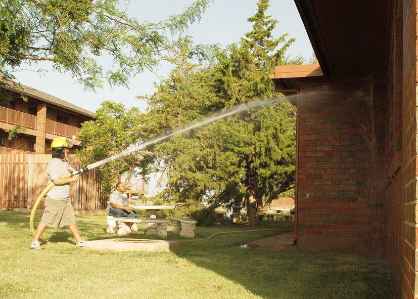 Senior Airman Todd Willis, 7th Civil Engineer Squadron, cleans the windows outside the Soul Fire Café here June 25. Airman Leadership School students volunteer to clean up the Soul Fire Café as part of a community service program. The Soul Fire Café is open to all Airman Thursdays 4:30- 9p.m. and Friday and Saturday 1 p.m. to 12a.m. (U.S. Air Force photo by Airman 1st Class Chelsea L. White)