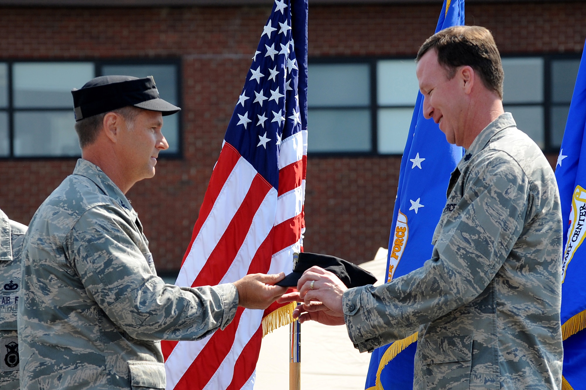 Col. Mark Ellis, Expeditionary Operations School commandant, presents the 421st Combat Training Squadron 'black-hat' to Lt. Col. David Lenderman July 13 during a change of command ceremony at Joint Base McGuire-Dix-Lakehurst, N.J.  Lt. Col. Mitchell Monroe relinquished command of the 421st CTS housed at the U.S. Air Force Expeditionary Center on Fort Dix. (U.S. Air Force Photo/Staff Sgt. Nathan G. Bevier) 