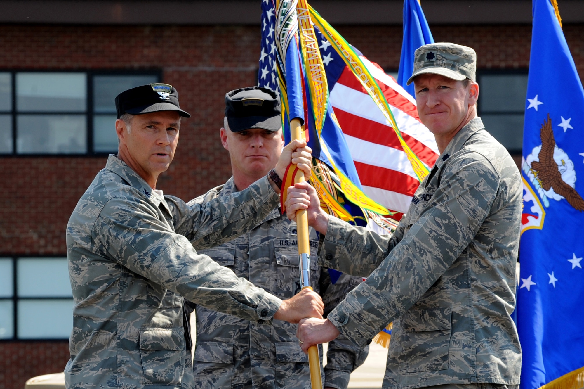 Col. Mark Ellis, Expeditionary Operations School commandant, presents the 421st Combat Training Squadron guidon to Lt. Col. David Lenderman July 13 during a change of command ceremony at Joint Base McGuire-Dix-Lakehurst, N.J.  Lt. Col. Mitchell Monroe relinquished command of the 421st CTS housed at the U.S. Air Force Expeditionary Center on Fort Dix. (U.S. Air Force Photo/Staff Sgt. Nathan G. Bevier) 