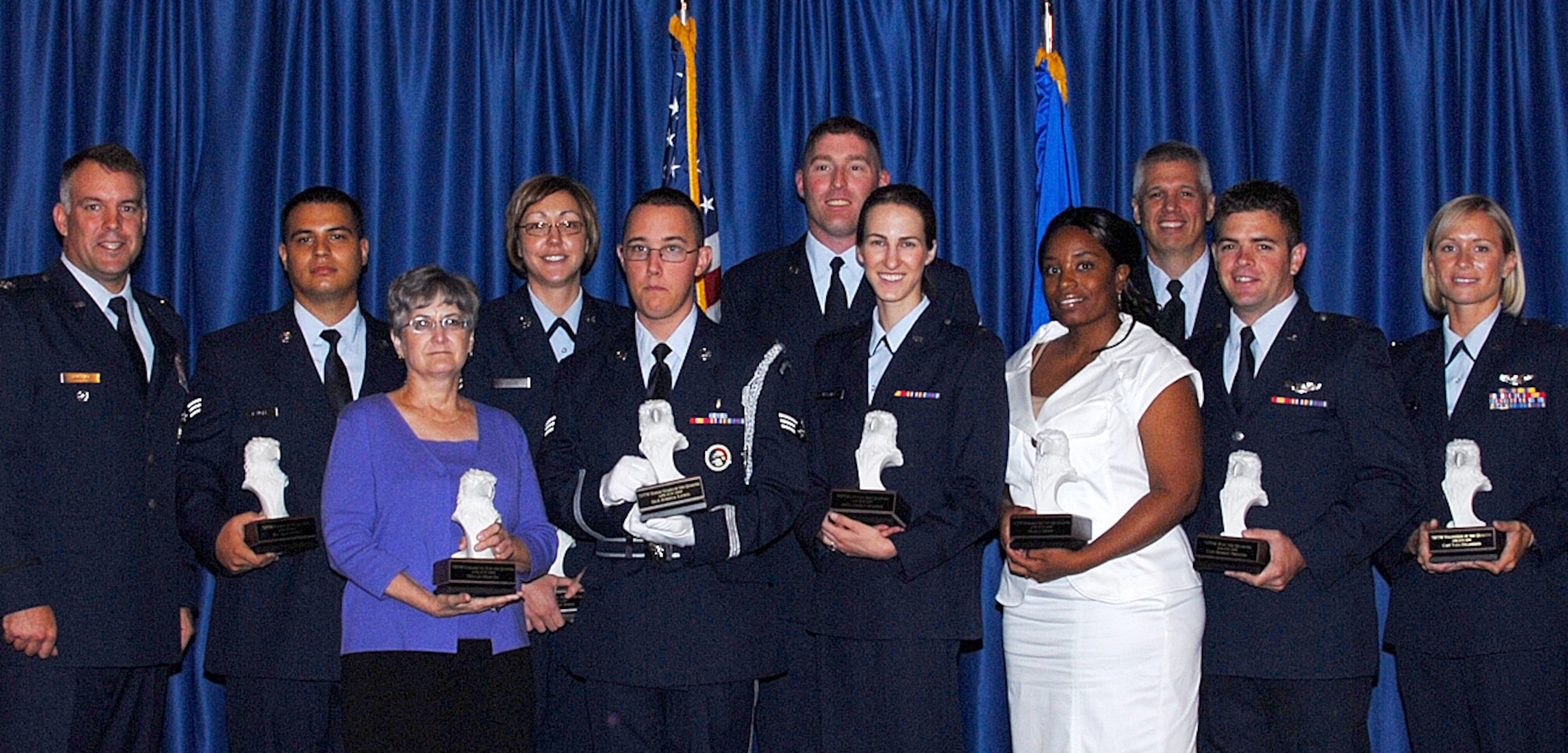 Recipients of the Wing Quarterly Awards were recognized during a luncheon held July 23 at the Vance Collocated Club. From left: Col. Richard Murphy, 71st Flying Training Wing vice commander; Airman of the Quarter, Senior Airman Jason Rangel, 71st Security Forces Squadron; Civilian of the Quarter, Category II, Nellie Martin, 71st Comptroller-Contracting Squadron; NCO of the Quarter, Tech. Sgt. Bobbie White, 71st Force Support Squadron; Honor Guard of the Quarter, Senior Airman Joshua Lewis, 71st Medical Support Squadron; Quality Assurance Personnel of the Quarter, Staff Sgt. Brian Page, 71st SFS; Company Grade Officer of the Quarter, 1st Lt. Agneta Murnan, Wing Staff Agency; Civilian of the Quarter, Category I, Tracy Hunt, 71st FSS; Chief Master Sgt. Kenui Balutski, 71st FTW command chief; Instructor Pilot of the Quarter, Capt. Robert Prenton, 25th Flying Training Squadron; and Volunteer of the Quarter, Capt. Tara Erlandson, 32nd FTS. Not in the photo is Senior NCO of the Quarter, Master Sgt. Steven Wilkins, 71st Medical Operations Squadron. (U.S. Air Force photo/ Angie Roche)