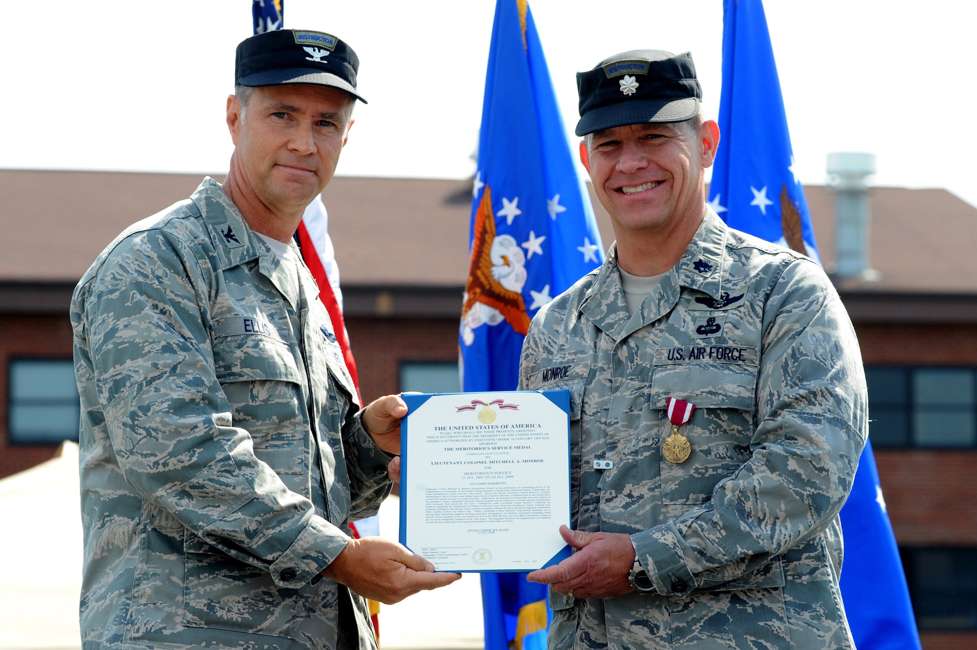 Col. Mark Ellis, Expeditionary Operations School commandant, awards Lt. Col. Mitchell Monroe, 421st Combat Training Squadron commander, with the meritorious service medal July 13 during a change of command ceremony at Joint Base McGuire-Dix-Lakehurst, N.J.  Lt. Col. David Lenderman will assume command of the 421st CTS housed at the U.S. Air Force Expeditionary Center on Fort Dix. (U.S. Air Force Photo/Staff Sgt. Nathan G. Bevier) 