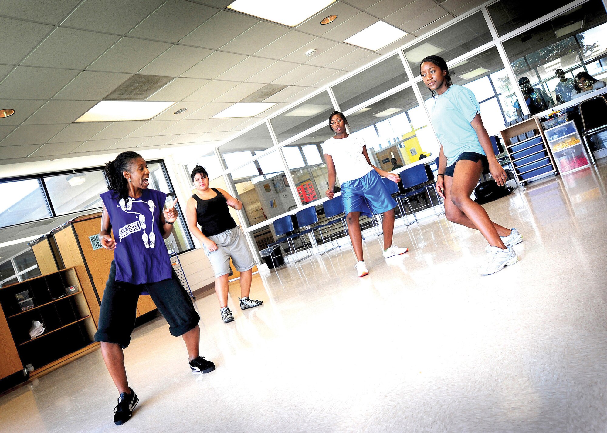 "Kapri," a Los Angeles, California native choreographer, instructs youth from the MacDill AFB Youth Center Dance Team at the youth center here July 14.  Members from the team consist of military dependants and meet regularly to enhance their dancing skills. (U.S. Air Force Photo by Airman 1st Class Rylan Albright/Released)