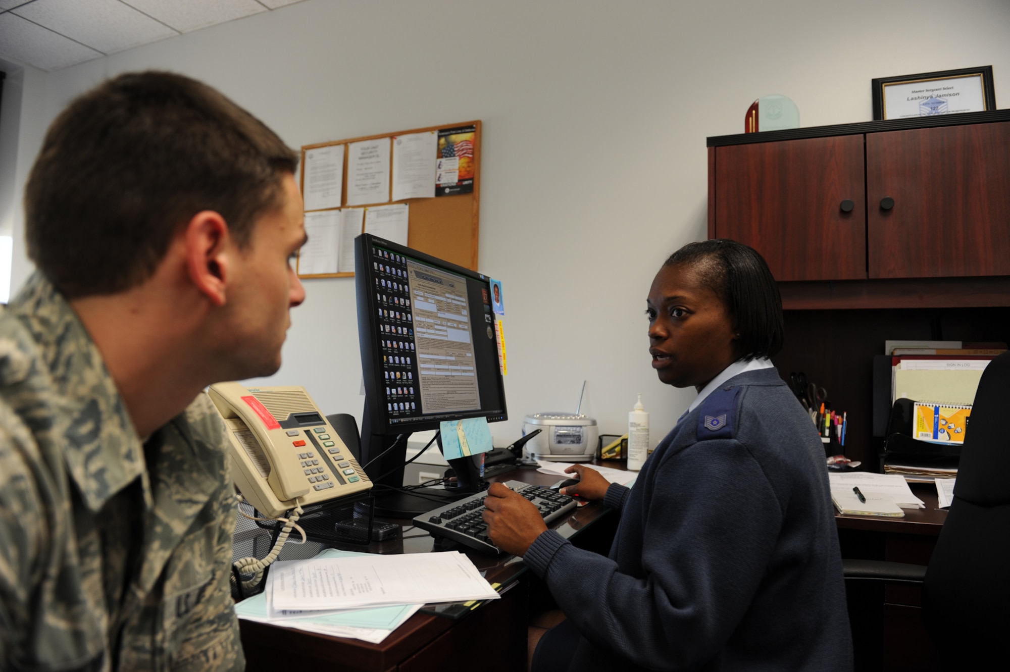 SHAW AIR FORCE BASE, S.C. -- Tech. Sgt. Lashinya Jamison, 20th Force Support Squadron, assists Airman 1st Class Bryan Anderson at the new one-stop section, July 27. The military personnel section has implemented an MPS one-stop shop July 15. The intent of the one-stop is to create an office for all military personnel issues and better customer service. (U.S. Air Force photo/Tech. Sgt.Vincent Mouzon)