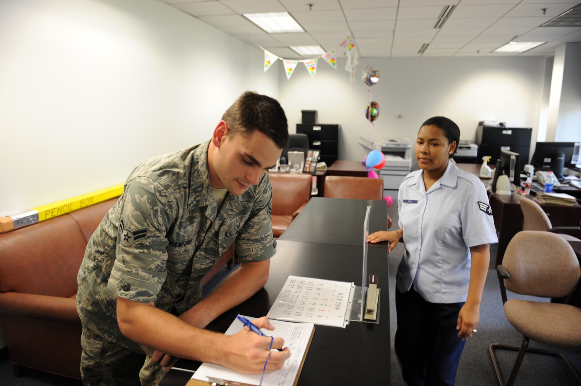 SHAW AIR FORCE BASE, S.C. -- Airman 1st Class Bryan Crawford, 20th Equipment Maintenance Squadron, signs in at the new one-stop section, July 27. The military personnel section has implemented an MPS one-stop shop July 15. The intent of the one-stop is to create an office for all military personnel issues and better customer service. (U.S. Air Force photo/Tech. Sgt.Vincent Mouzon)