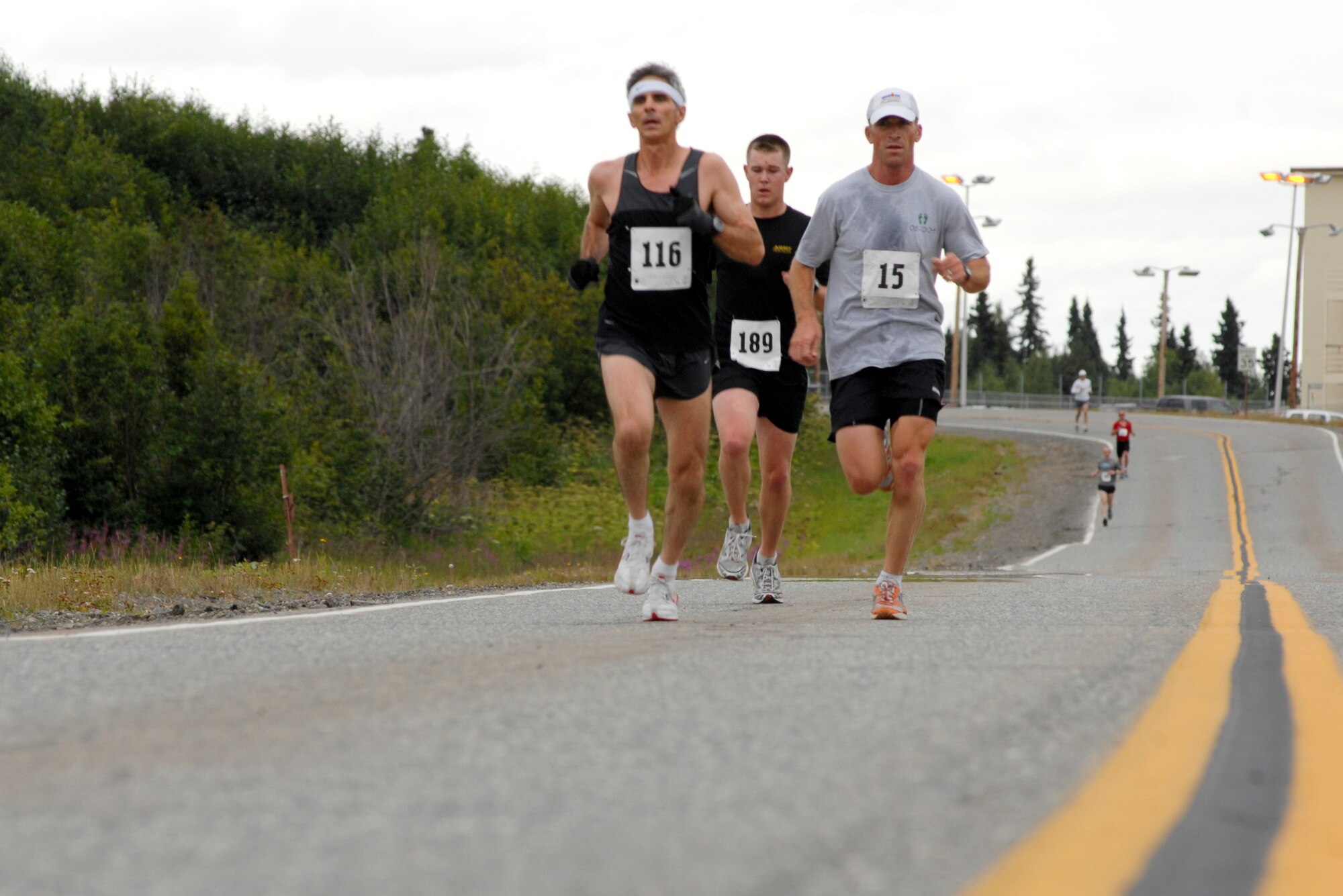 ELMENDORF AIR FORCE BASE, Alaska -- A trio of half marathon runners keep pace as they pass the 381st Intelligence Squadron on their way to the turnaround spot near 611th Chalet July 25. About 100 runners participated in this year's half marathon. (U.S. Air Force photo/Senior Airman David Carbajal)