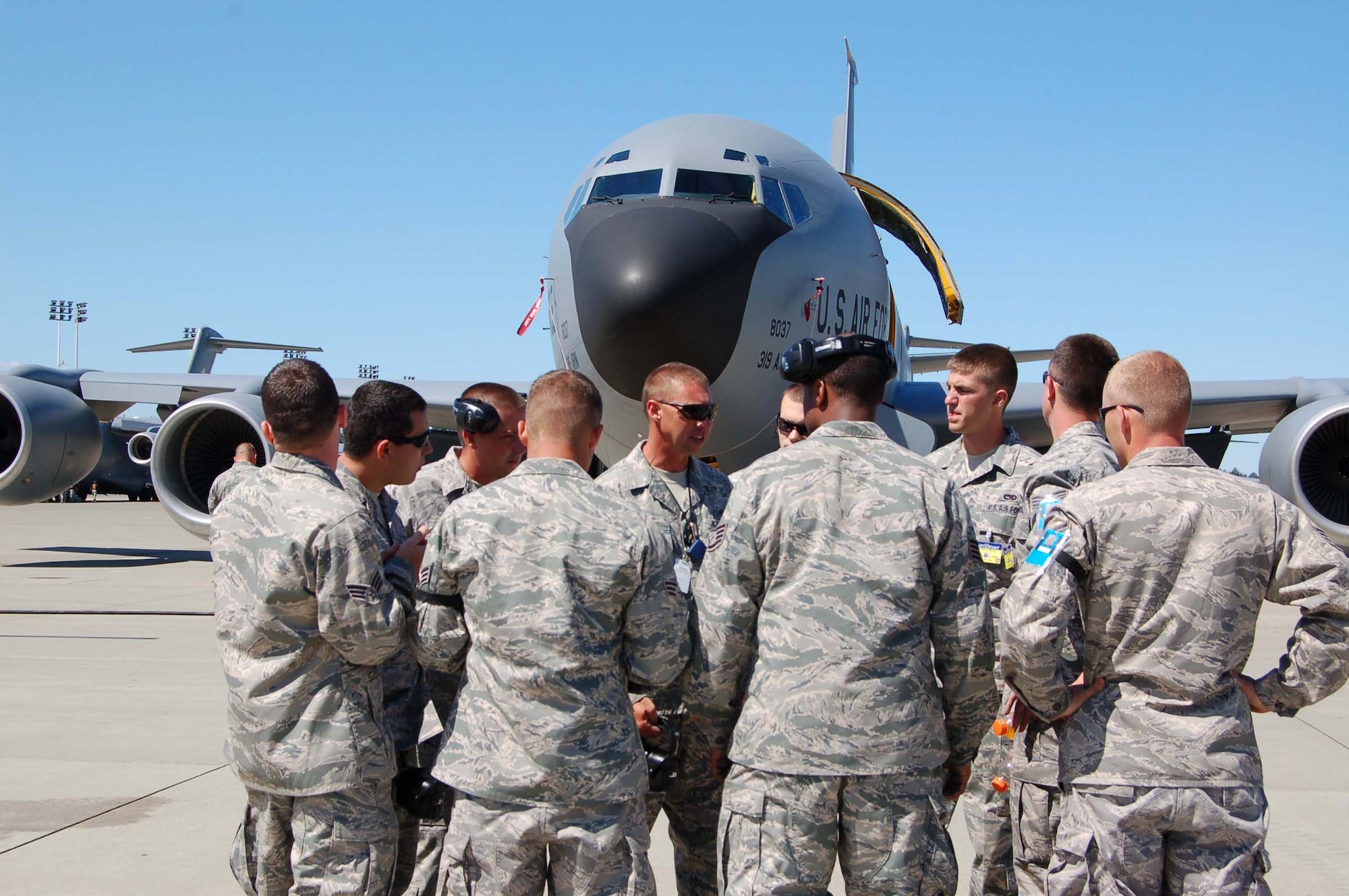 Maintainers from the Grand Forks Air Force Base's 2009 RODEO team gather as RODEO umpires inspect their KC-135 during the competition July 19. Umpires have one hour to inspect the jet, during which time, team members' watch each passing moment with increased anxiety.  (U.S. Air Force photo/Tech. Sgt. Amanda Callahan)