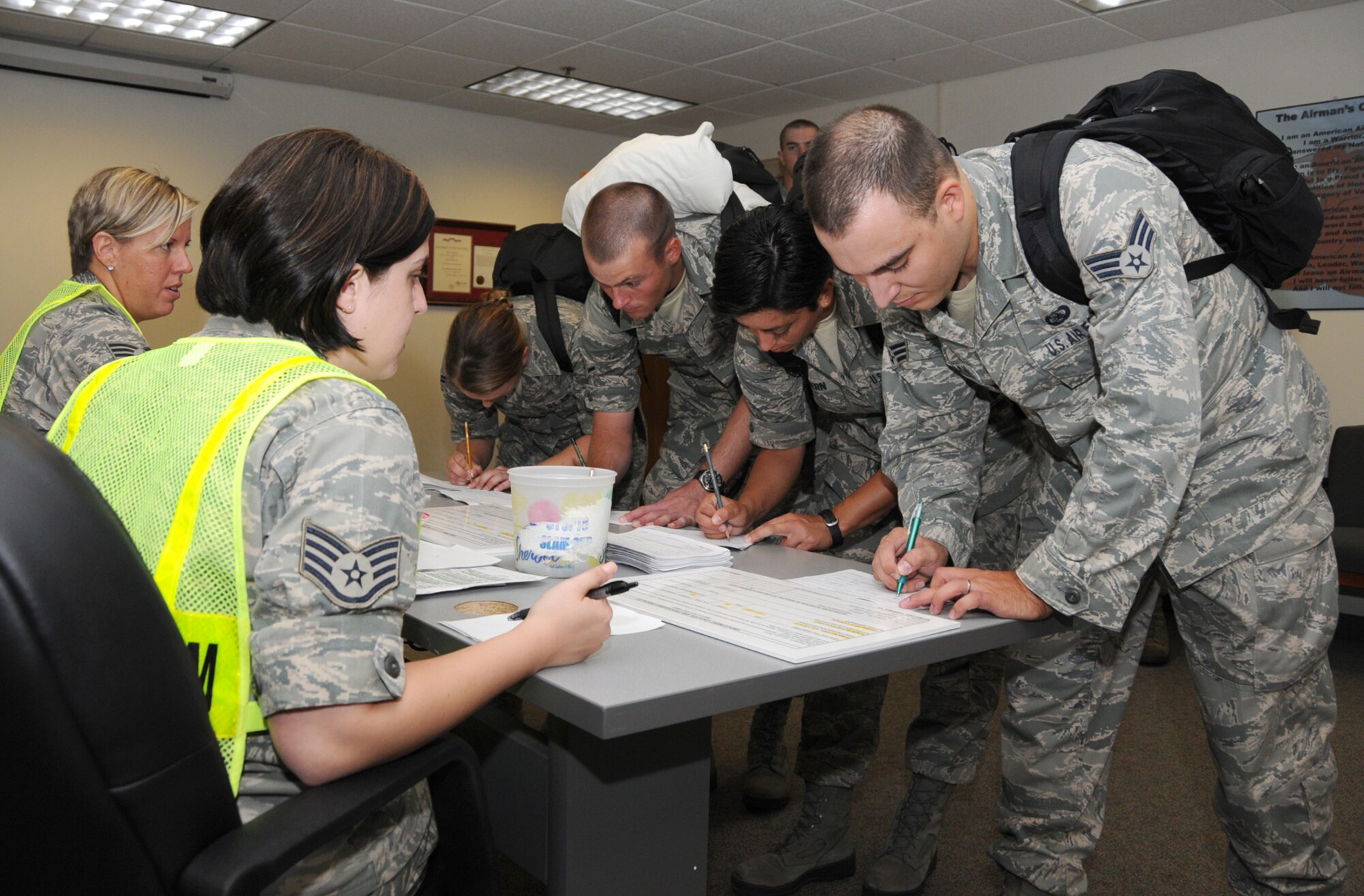 From left, Tech. Sgt. Jodi Schmidt and Staff Sgt. Jan Turner, shelter management team members, process Airman 1st Class Laurel Hutchins, Airman David Lukin, Airman Basic Lacey Freebern and Senior Airman Matt Jackson into the Wolfe Hall shelter Friday during Keesler's hurricane exercise.  All are members of Keesler's 335th Training Squadron except Airman Jackson, who's assigned to the 81st Communications Squadron.  Keesler conducted a four-day exercise this week with a fictional Hurricane Taylor to test the base's emergency responses, sheltering plan and evacuation processes.  Base officials use the experience to address any issues that may arise to fine-tune Keesler's readiness for any future storms.  (U.S. Air Force photo by Kemberly Groue)