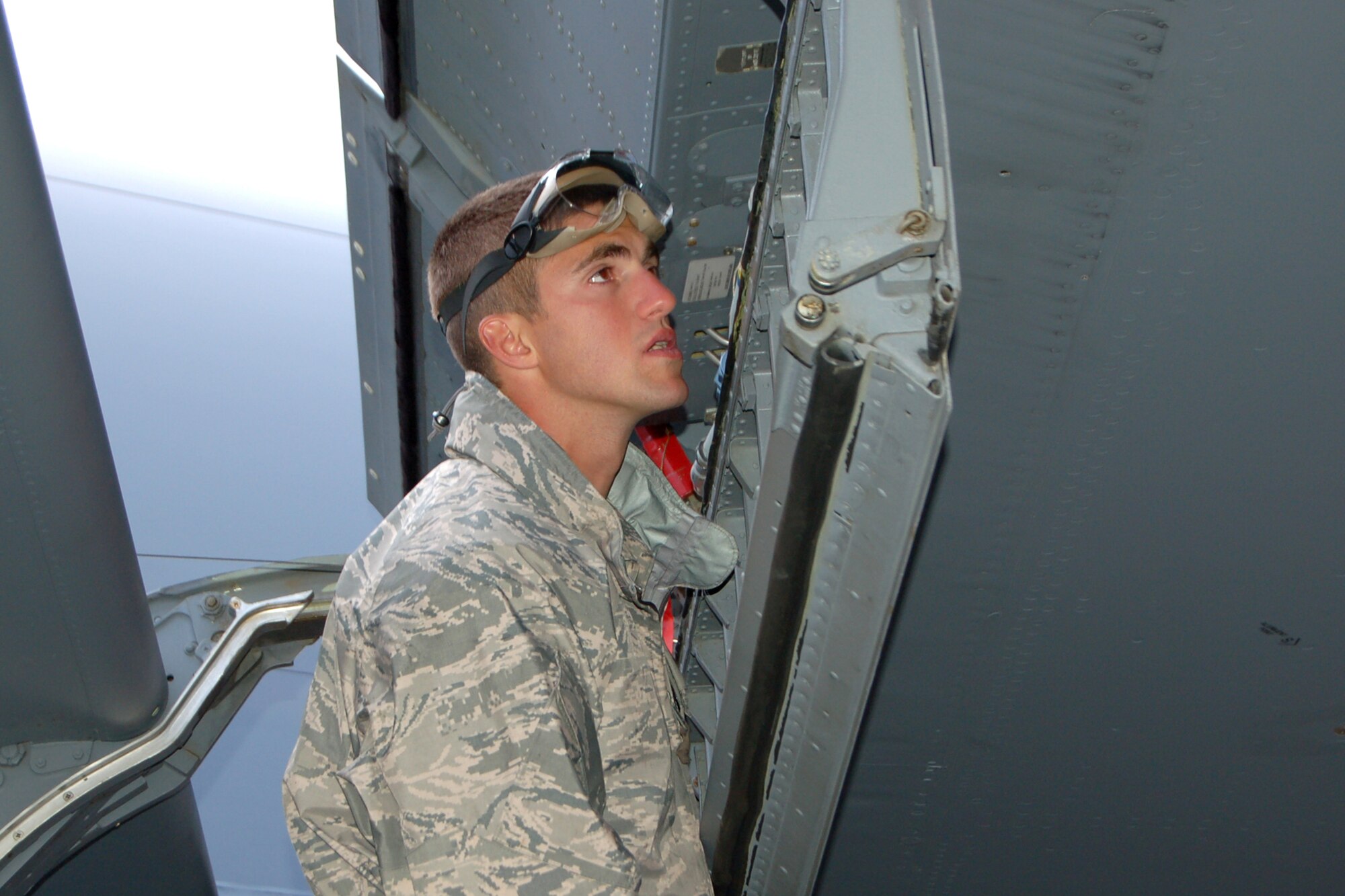 Senior Airman Jason Monnin, 319th Aircraft Maintenance Squadron, closely inspects a Grand Forks AFB KC-135 in preparation for a competition event during the 2009 Air Mobility RODEO July 23. (U.S. Air Force photo/Tech. Sgt. Amanda Callahan)