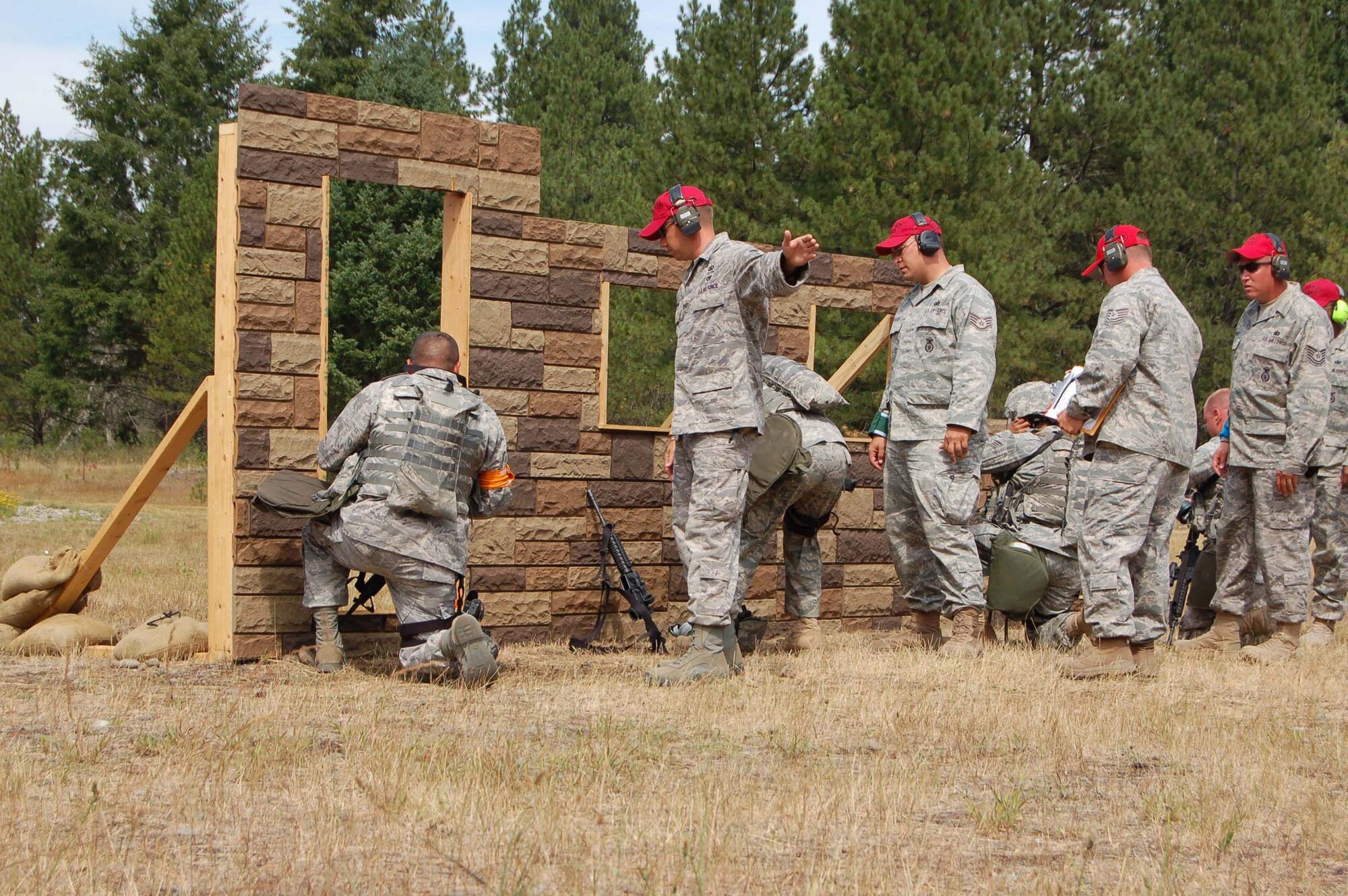 319th Air Refueling Wing security forces defenders perform line up to fire M9 pistols and M4 rifles at targets donned with glass plates during the combat weapons course at the Air Mobility RODEO July 20. (U.S. Air Force photo/Tech. Sgt. Amanda Callahan)
