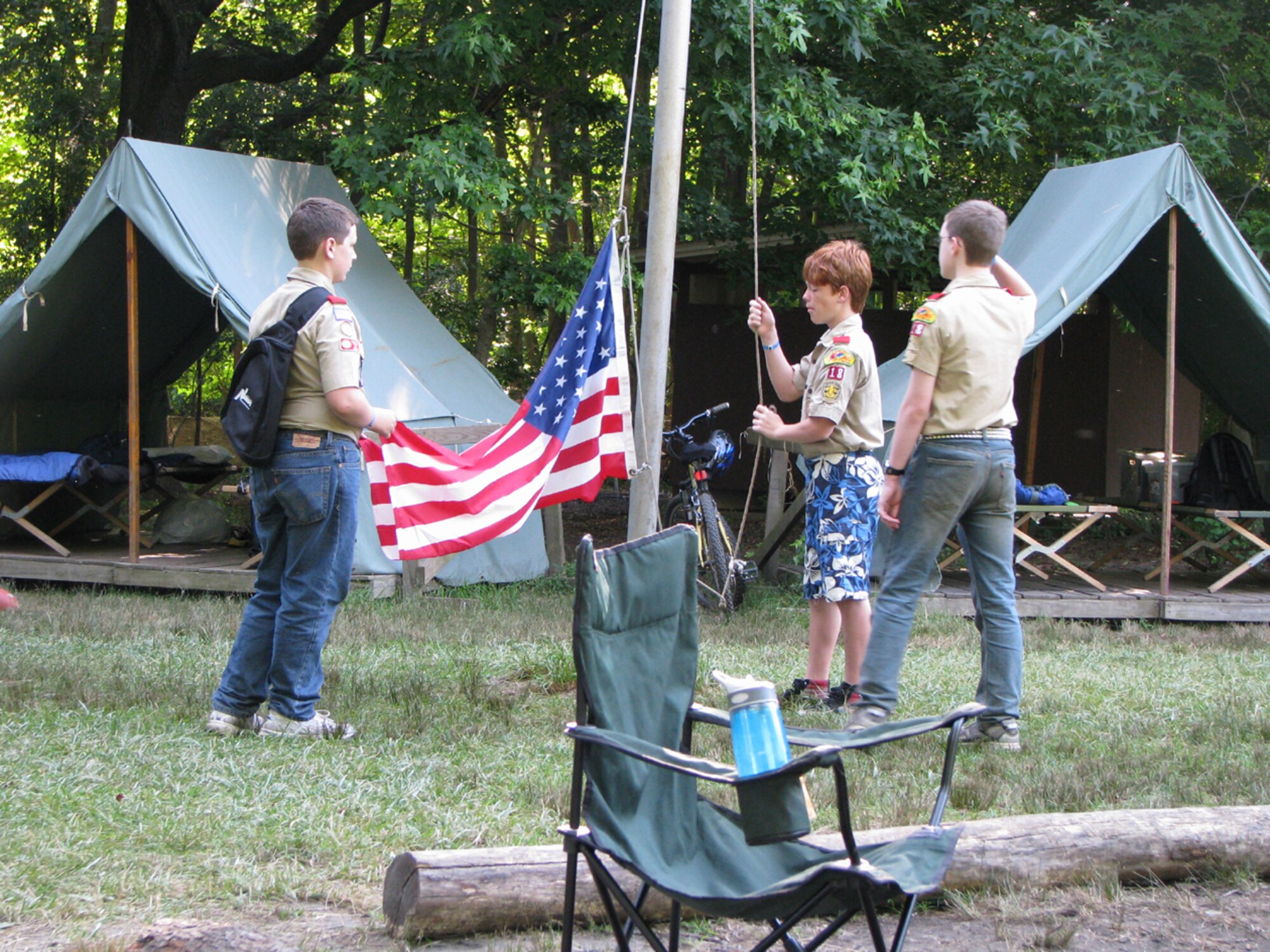Scouts from Troop 18, based out of McGuire Air Force Base, N.J., raise the flag during a summer camp in Maryland. With one of the more active programs in the area, Troop 18 manages an average of 10 weekend campouts per year along with other day-trip events. (Courtesy photo)